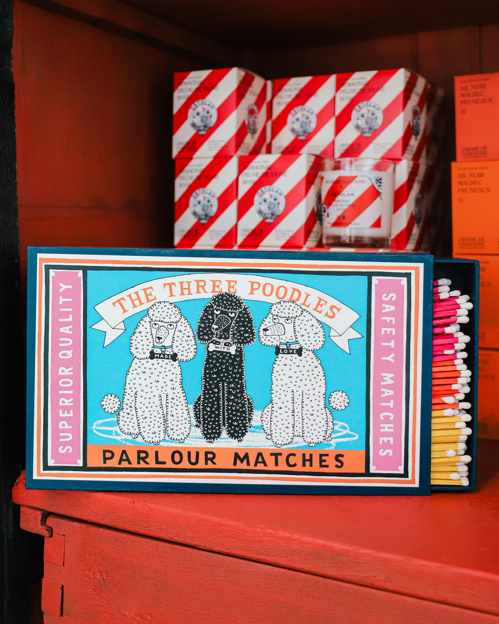 Archivist Gallery matchbox with three illustrated poodles and multicolored matches, available at Wildschut Antiques