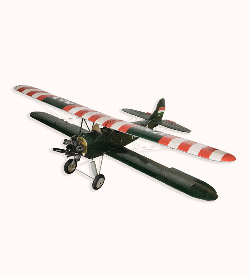 Vintage biplane model, a detailed 1970s replica of the 1954 Ha-Pao aircraft, captured mid-flight against a clean background. Available at Wildschut Antiques.