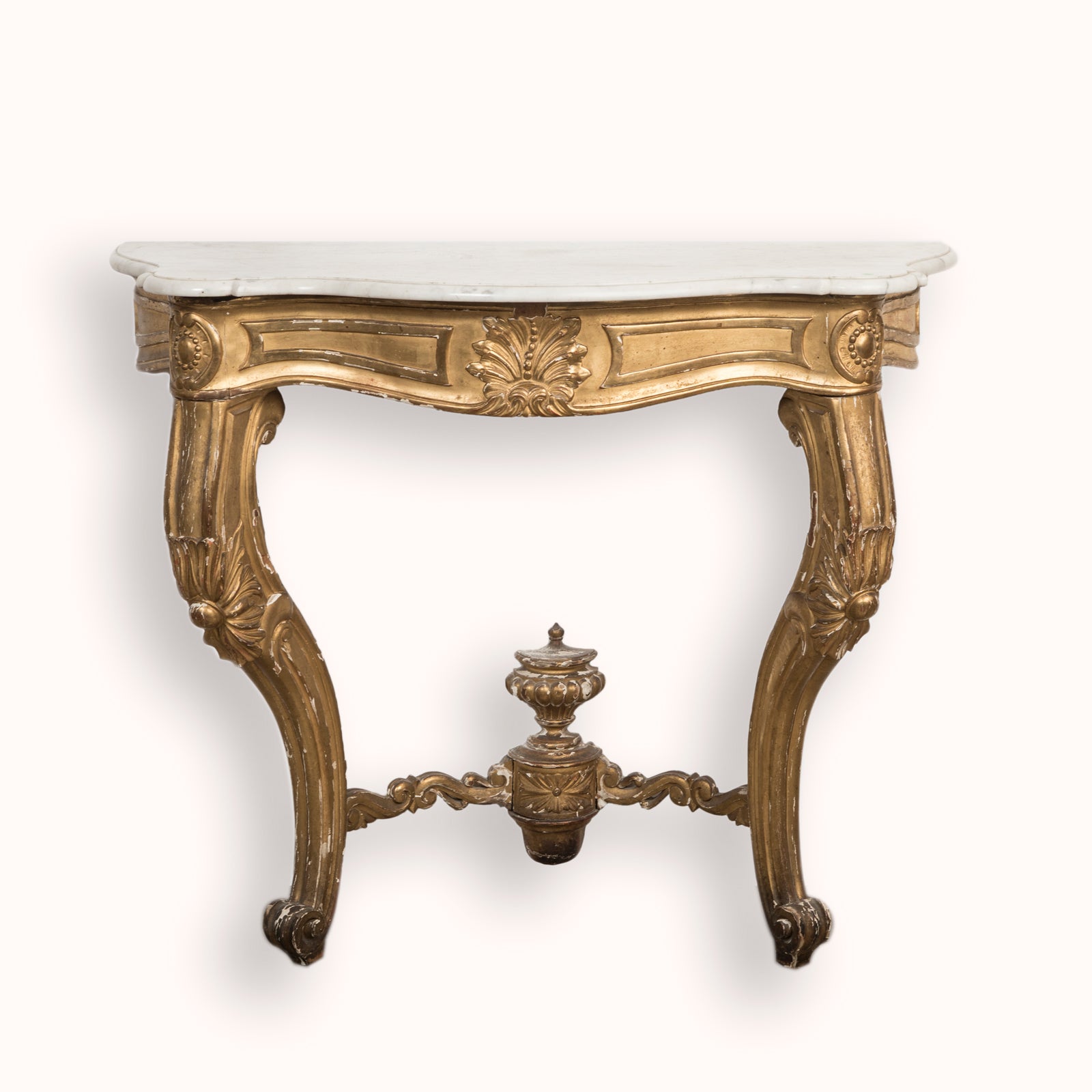A highly decorative antique French Louis XV style gilt wood console table with a white marble top, featuring intricate gilded designs and resting on carved legs, available at Wildschut Antiques