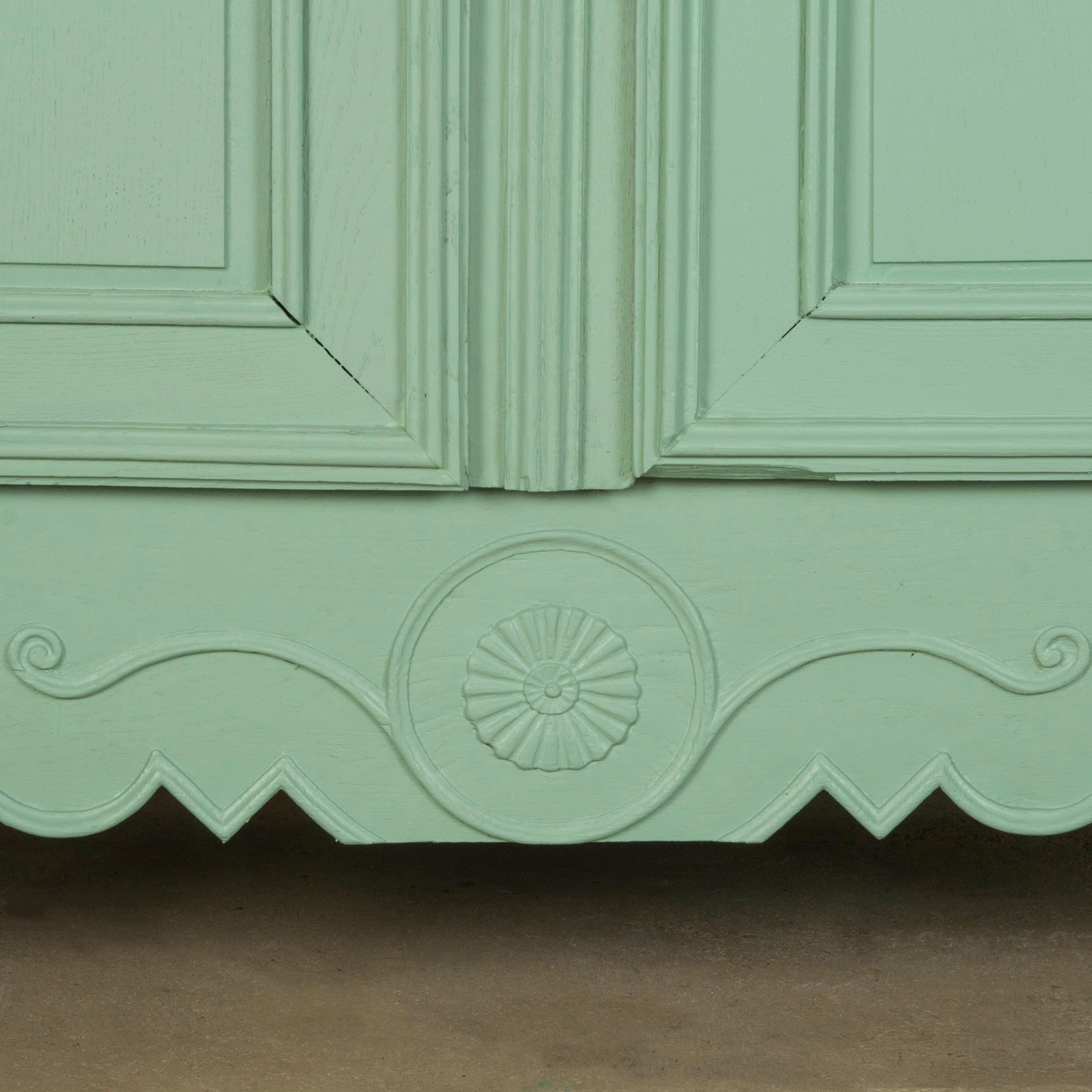 Close-up of a 19th-century green French marriage armoire with carved foliage motifs from Wildschut Antiques