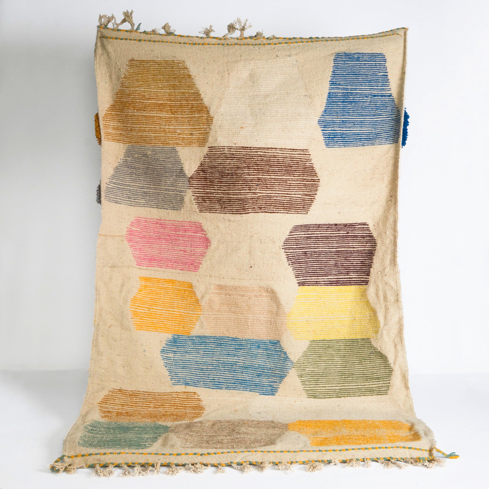 Backside of a vintage 1970s Moroccan rug featuring an abstract composition of vibrant, irregularly shaped tufts in bold colors—such as cobalt blue, mustard yellow, fuchsia, burnt orange, and olive green.