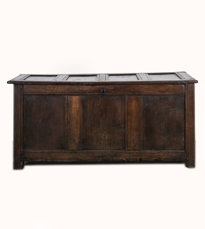 Antique early 18th-century solid oak chest or coffer, paneled and carved in warm brown tones. Displayed against a clean background. Available at Wildschut Antiques.