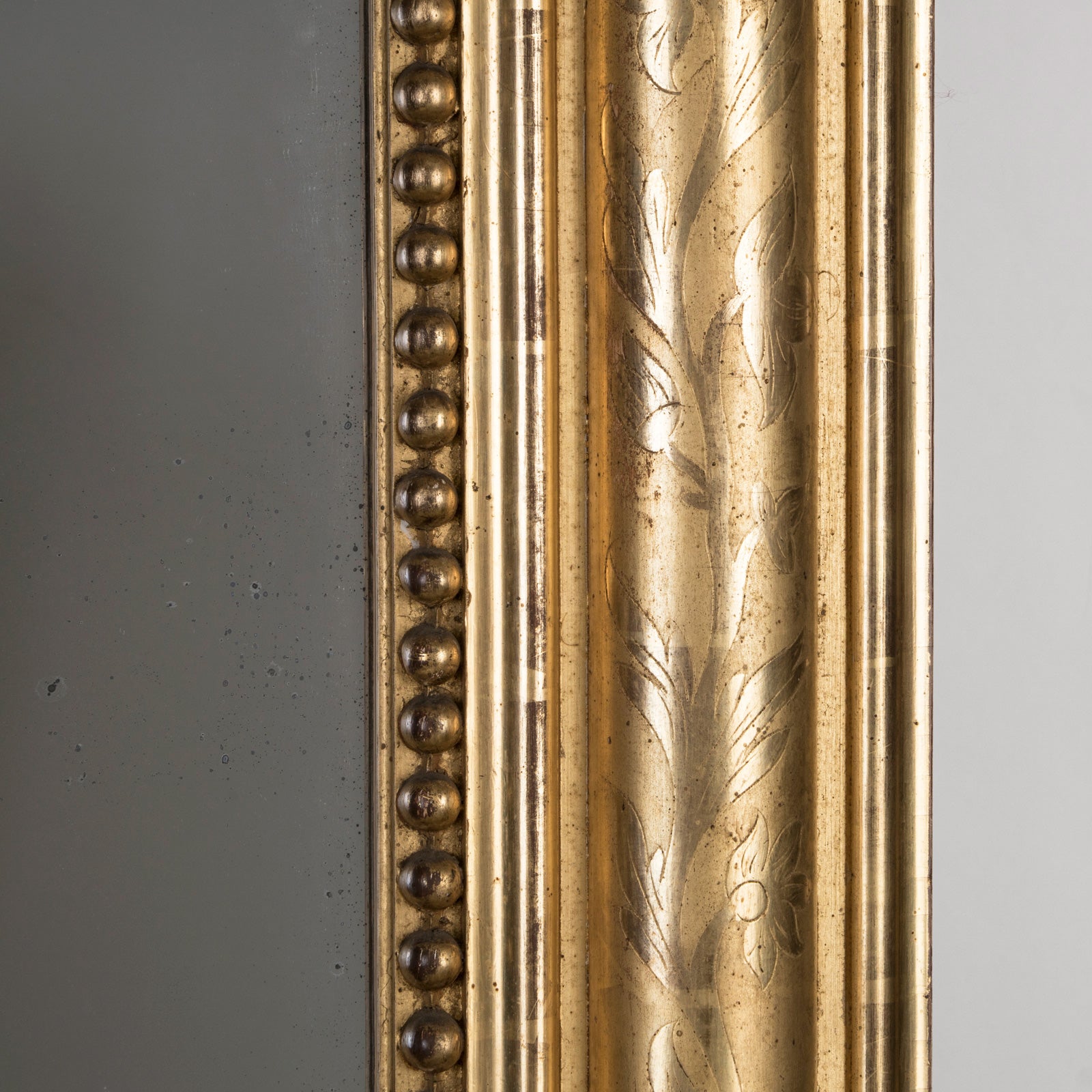 Close-up of the frame of a large Antique French 19th Century gold gilt mirror