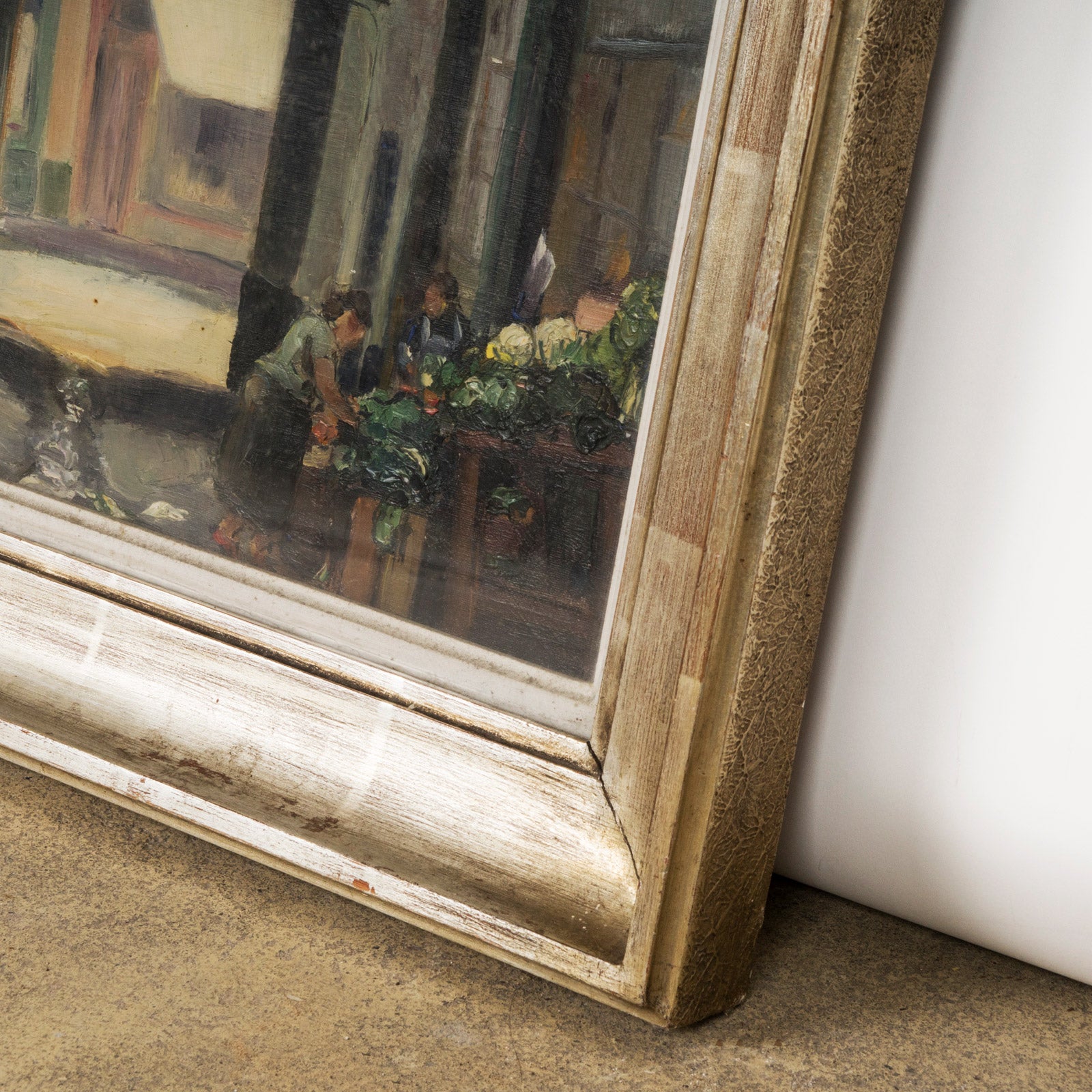 Detail of a vintage oil painting depicting a narrow street in Brussels with houses and a small grocery stand, signed by F. Jorwitz and encased in a 1950s-60s style frame