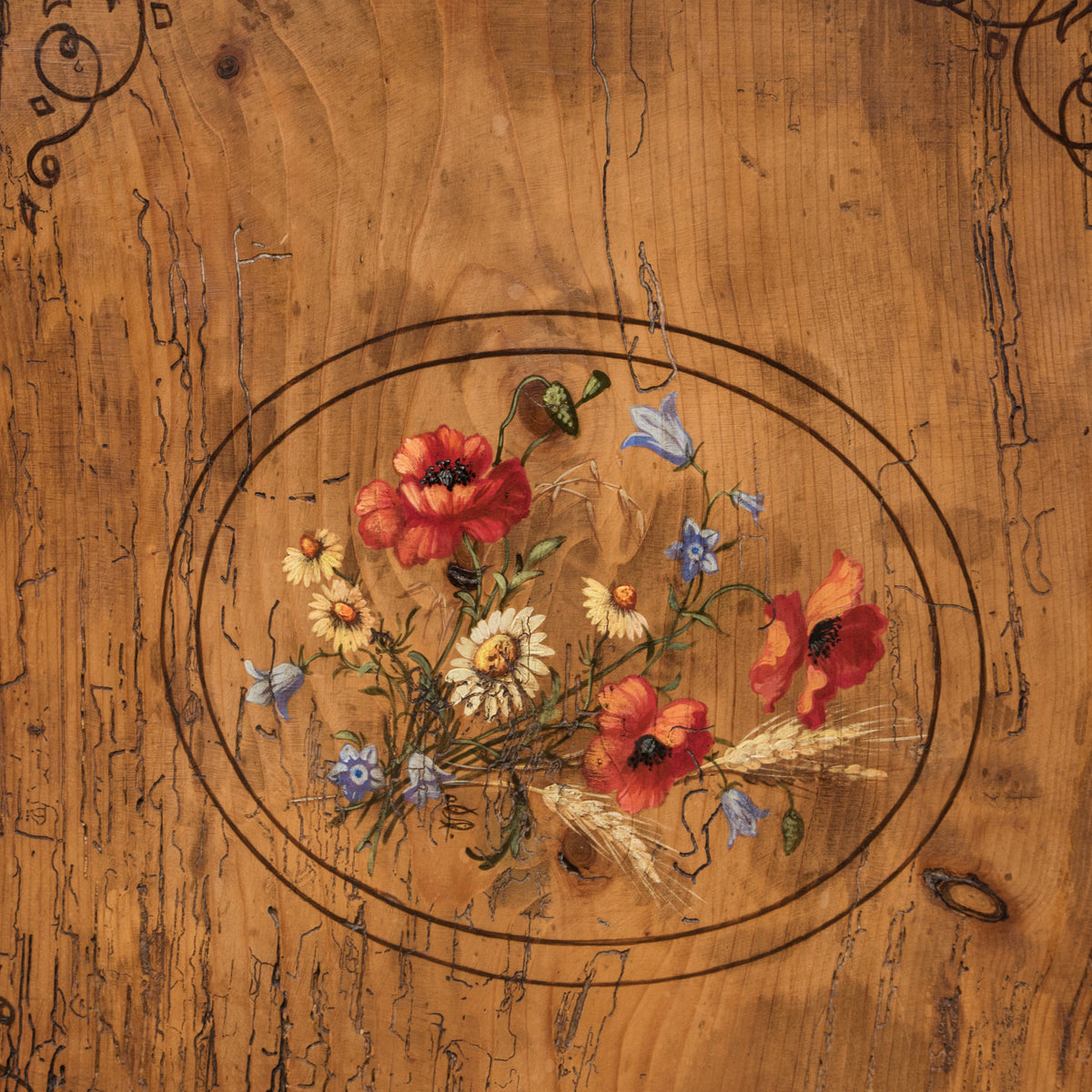 Close-up of a charming antique French tall case clock with a painted pine case decorated with floral motifs