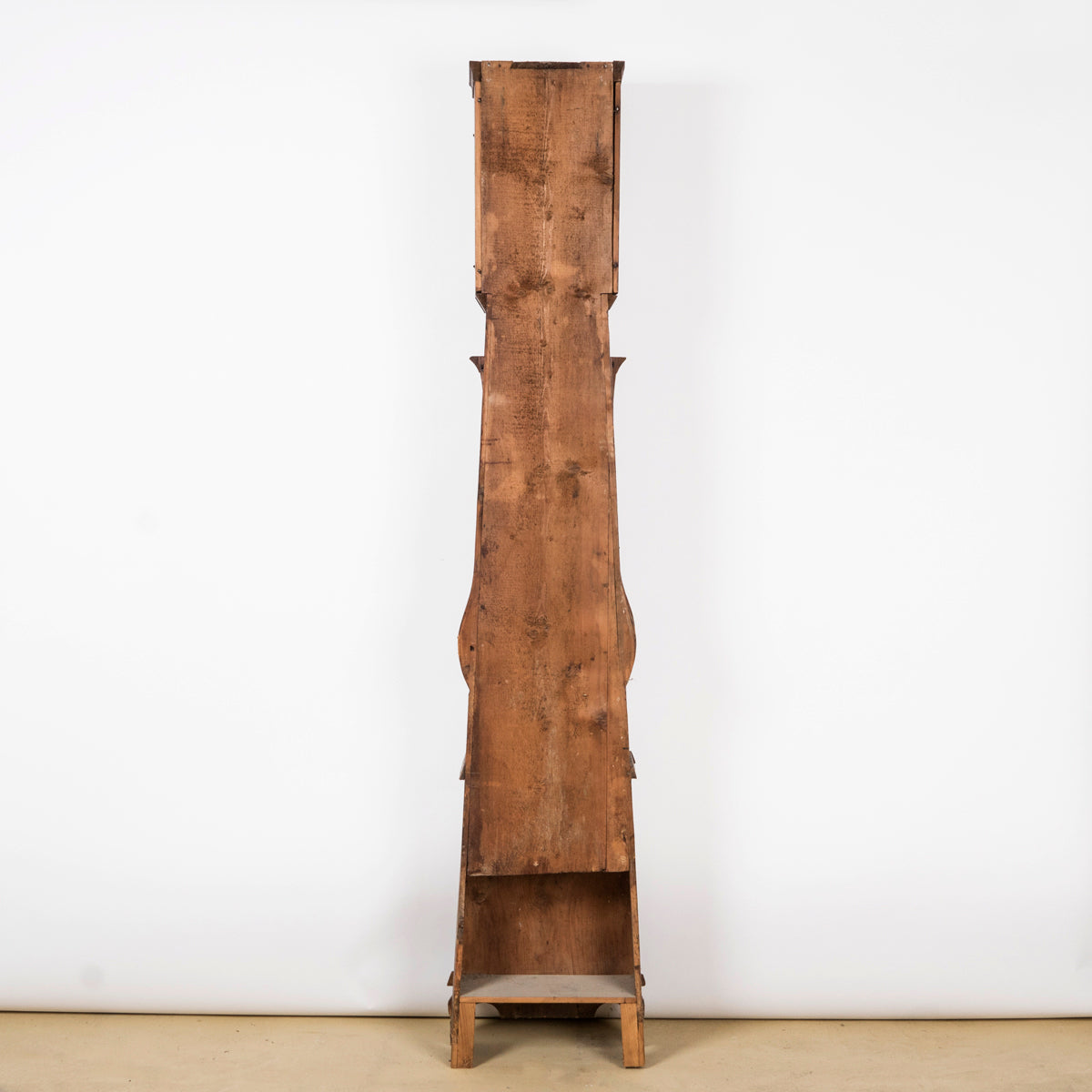 Wooden backside of a charming antique French tall case clock with a painted pine case