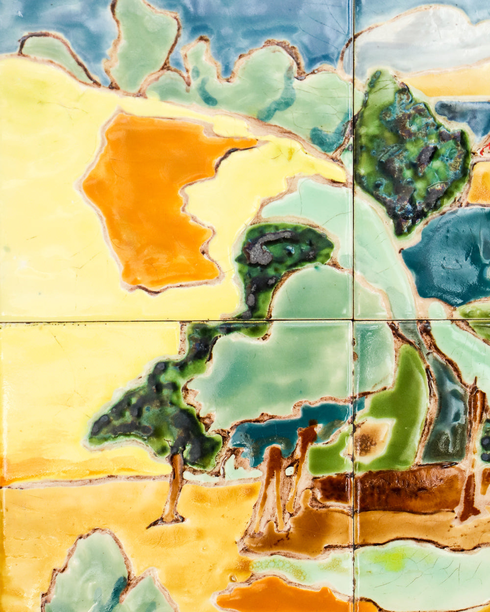 Close-up of a colorful mid-century French ceramic glazed tile panel depicting the scenic village of Anduze, famed for its pottery factories.