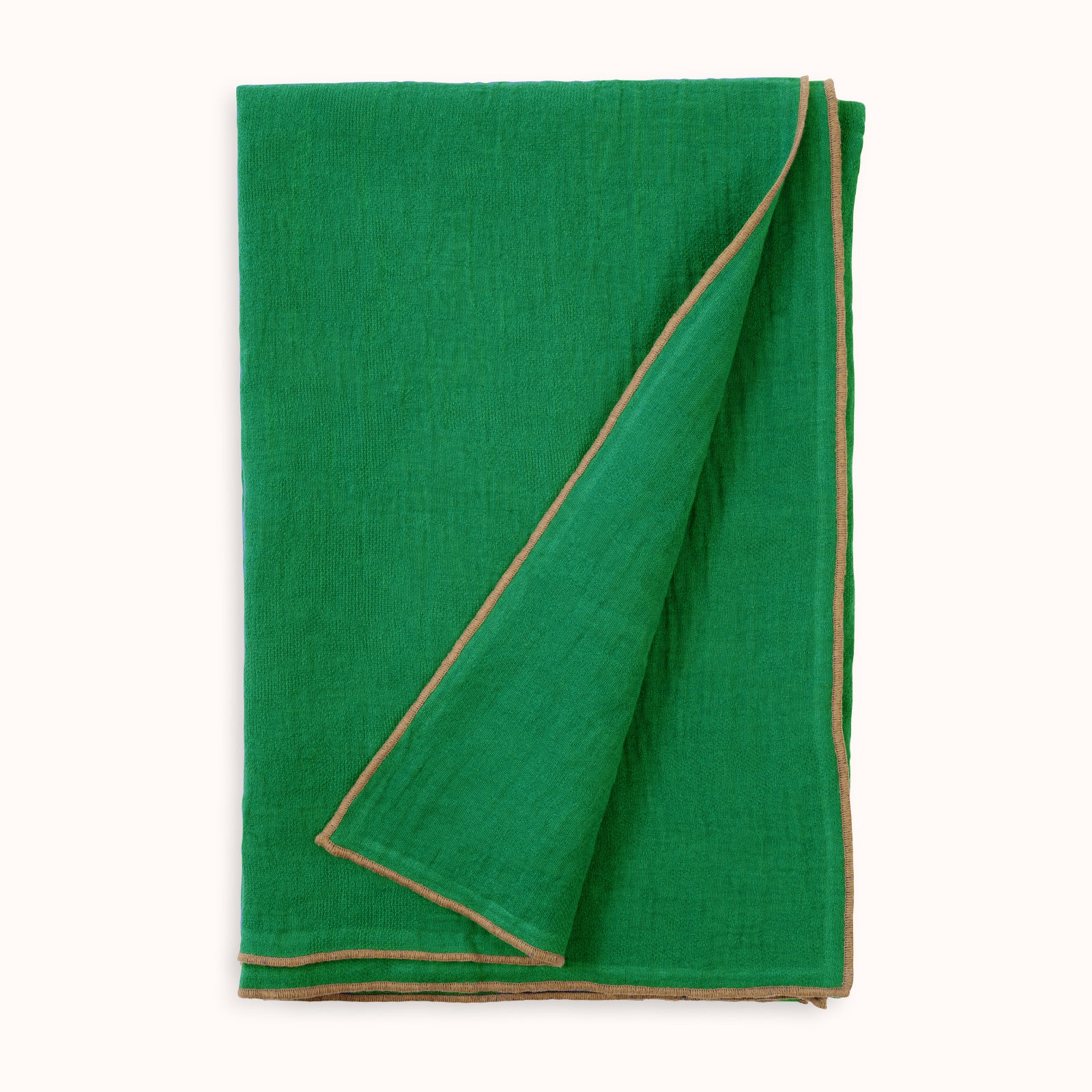 An apple green soft linen blend throw blanket with contrasting beige decorative seams, folded neatly and available at Wildschut Antiques