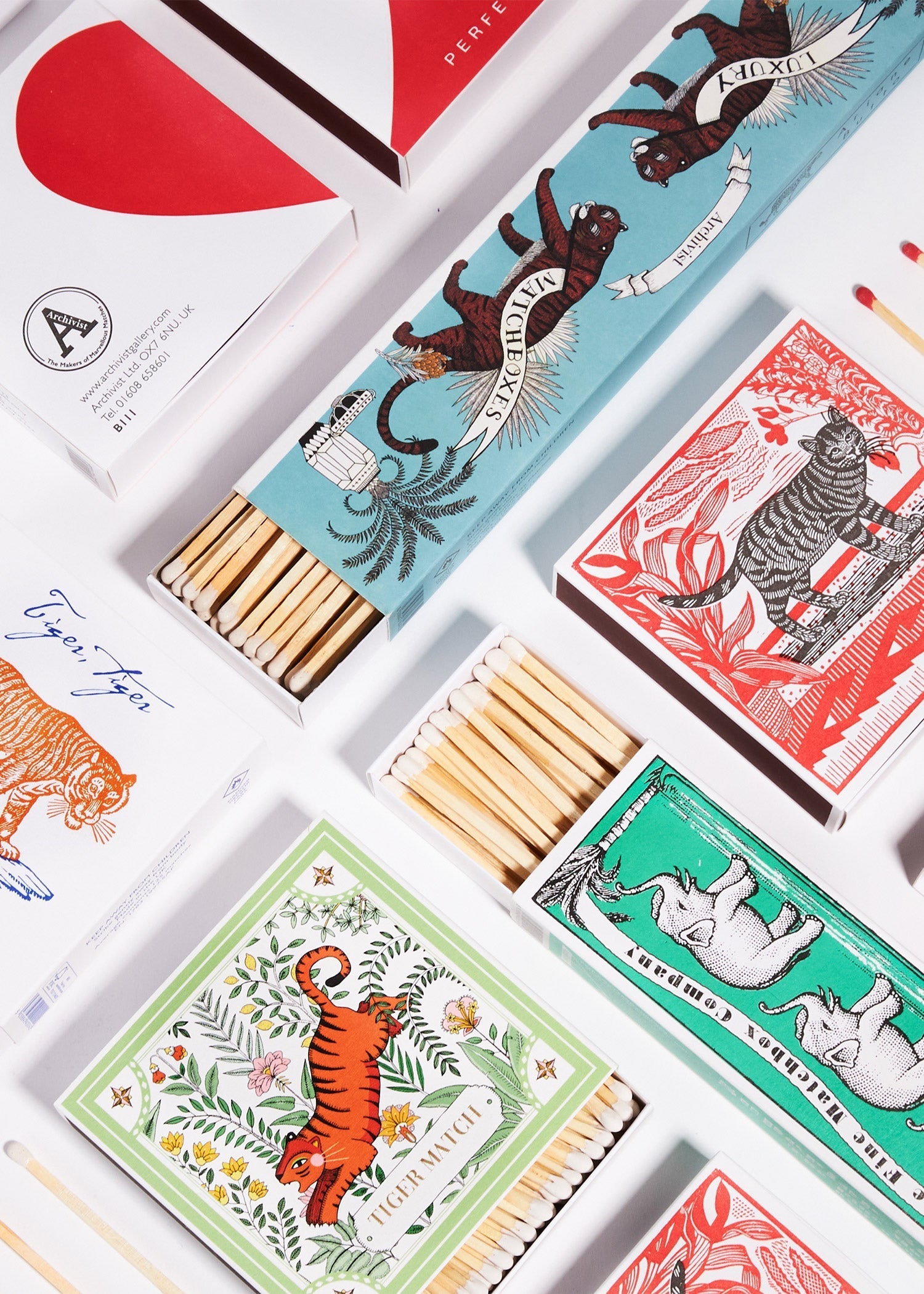 A vibrant collection of matchboxes featuring tigers, elephants, and a cheeky cat by Archivist Gallery — available at Wildschut Antiques