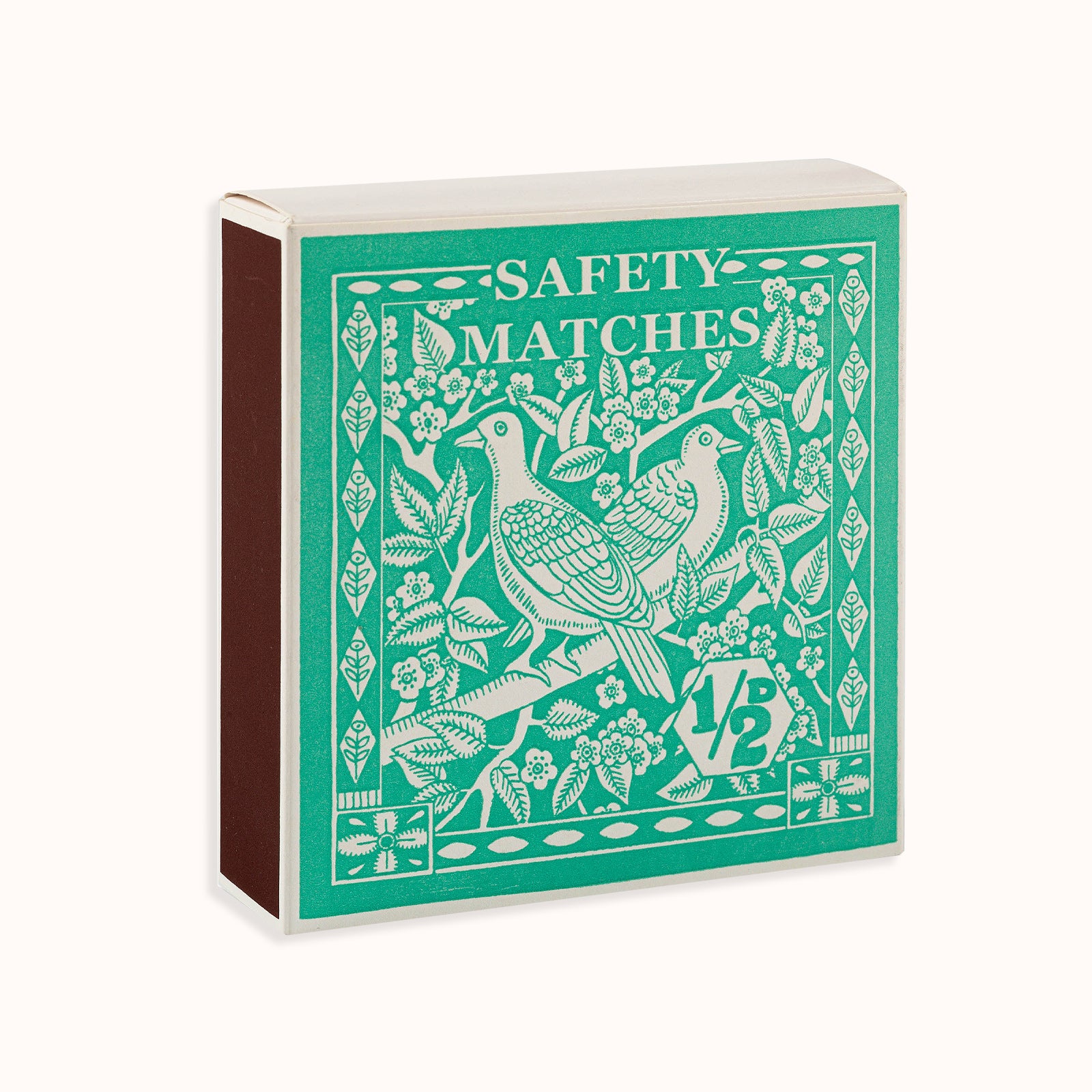A green matchbox featuring an artistically designed bird and floral pattern, labeled 'Safety Matches'. Part of the Archivist Gallery collection, available at Wildschut Antiques.
