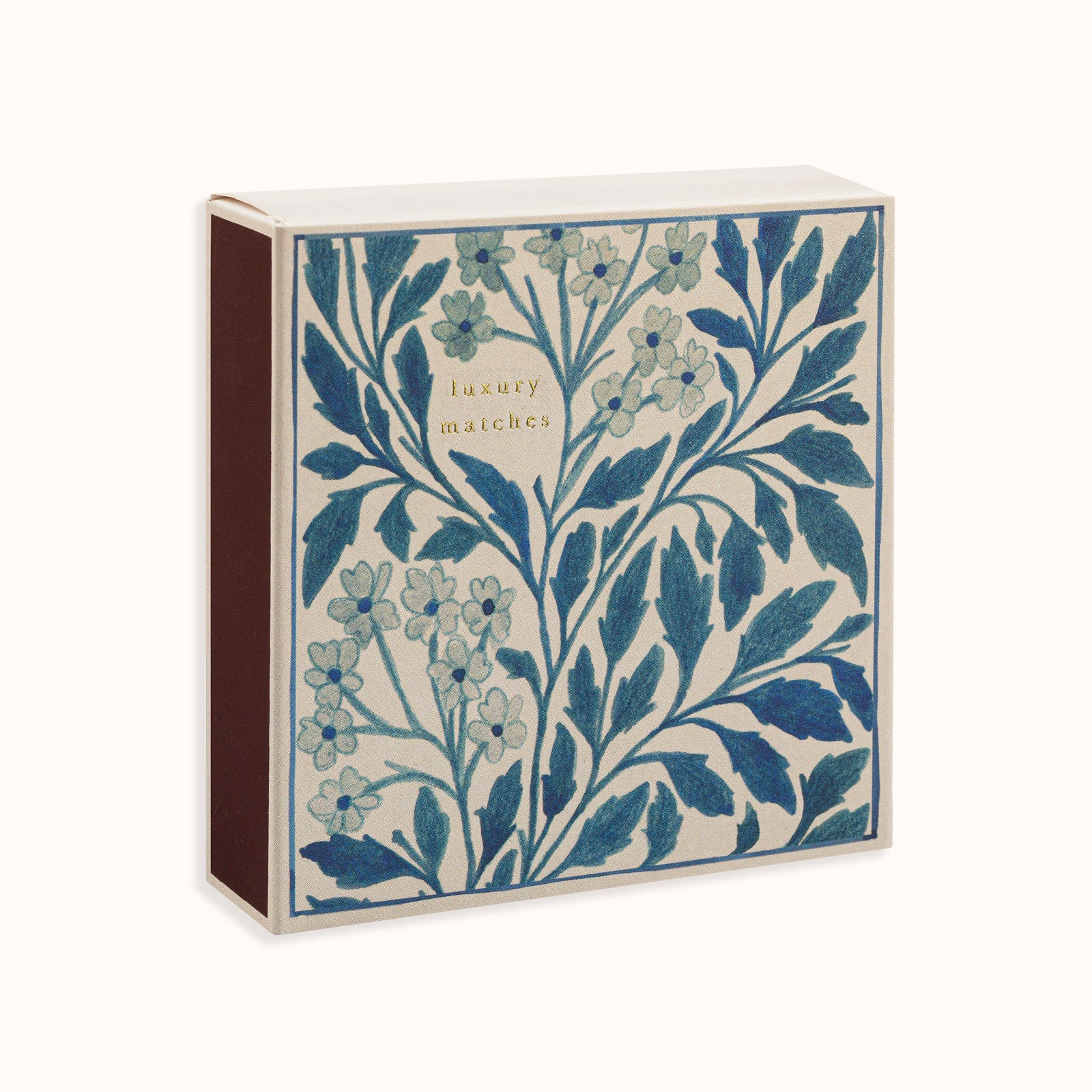 A matchbox with a blue floral design, part of the Archivist Gallery Collection and available at Wildschut Antiques.