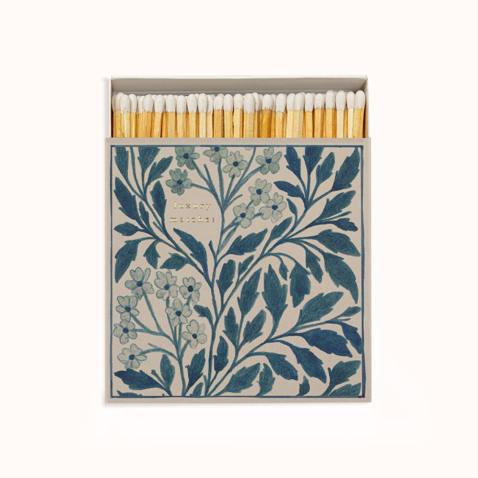 A matchbox with a blue floral design, the matches are visible inside the box which has a clear lid on top. Part of the Archivist Gallery Collection and available at Wildschut Antiques.
