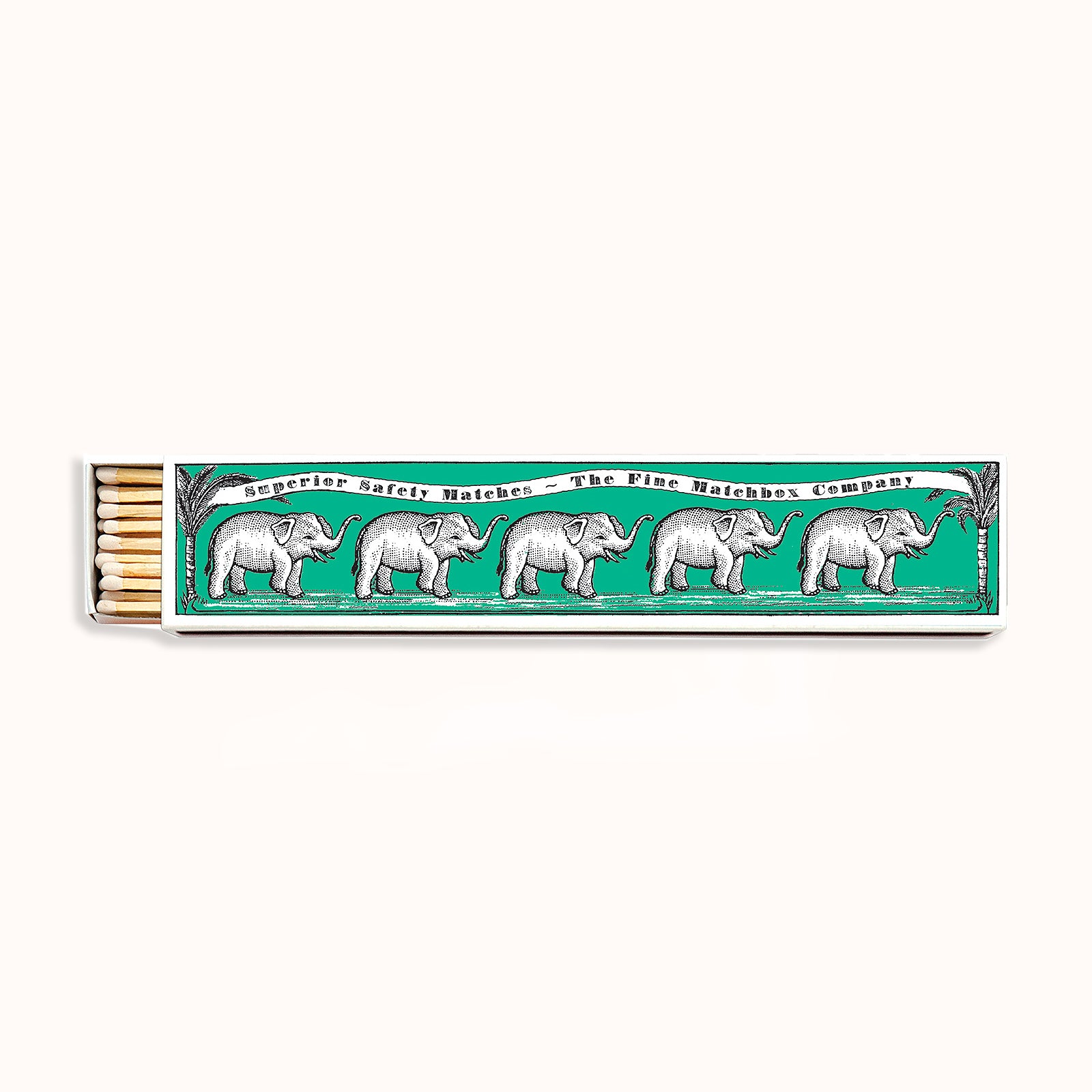 A long matchbox with a green background and illustrations of elephants in a repeating pattern. Part of the Archivist Gallery Collection, available at Wildschut Antiques.