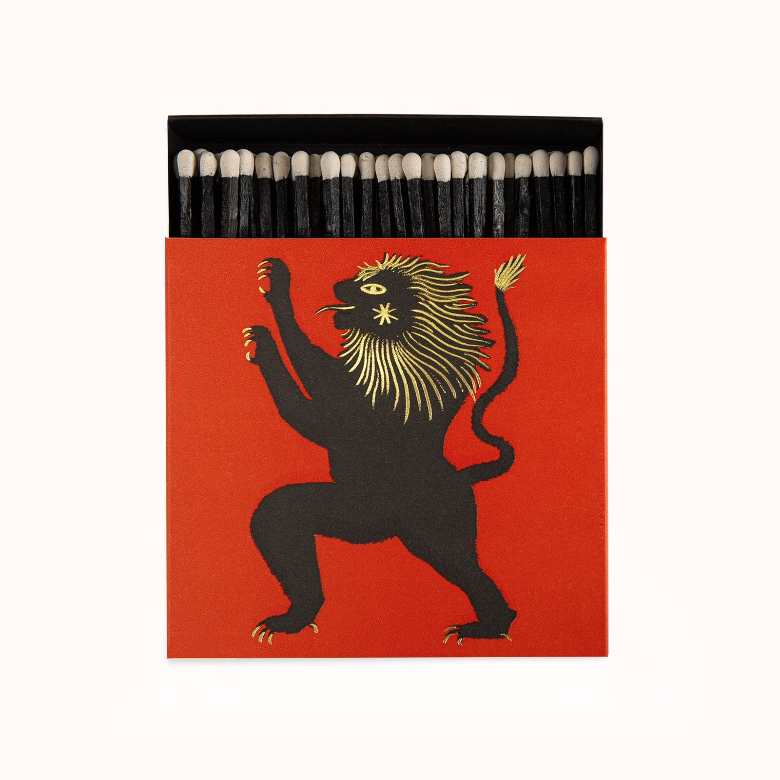 Matches in a decorative Archivist Gallery matchbox featuring a black lion with golden details, displayed on a neutral background, available at Wildschut Antiques.