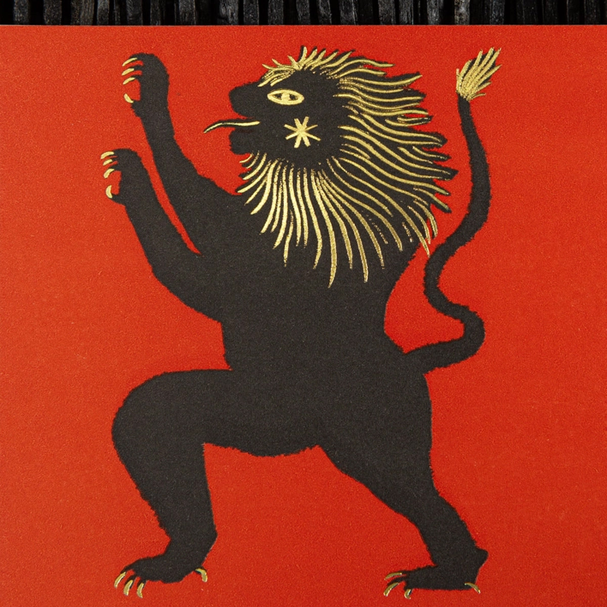 Black and gold lion emblem on a red background