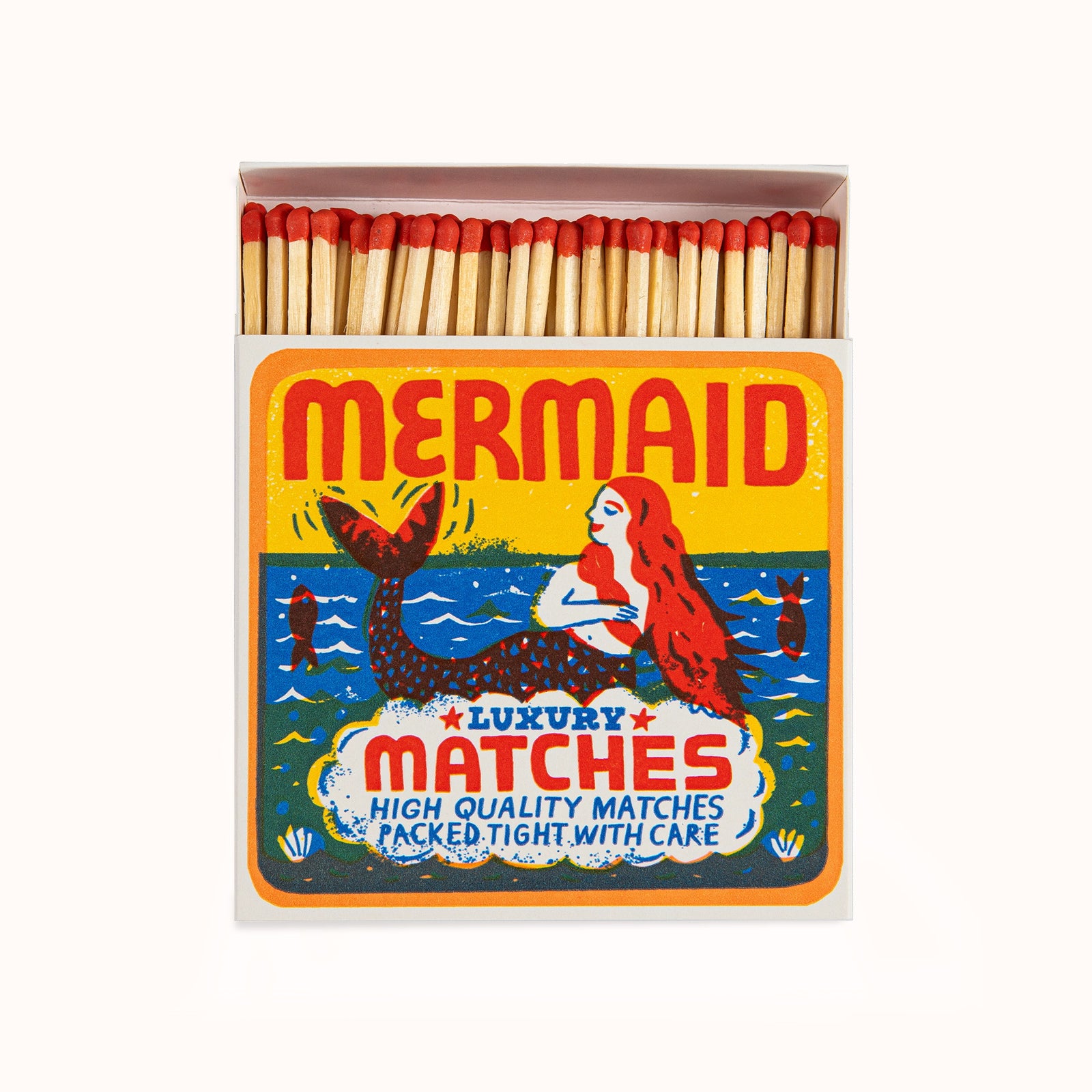 Matches in a decorative Archivist Gallery matchbox featuring a colorful mermaid design, set against a neutral background, available at Wildschut Antiques.