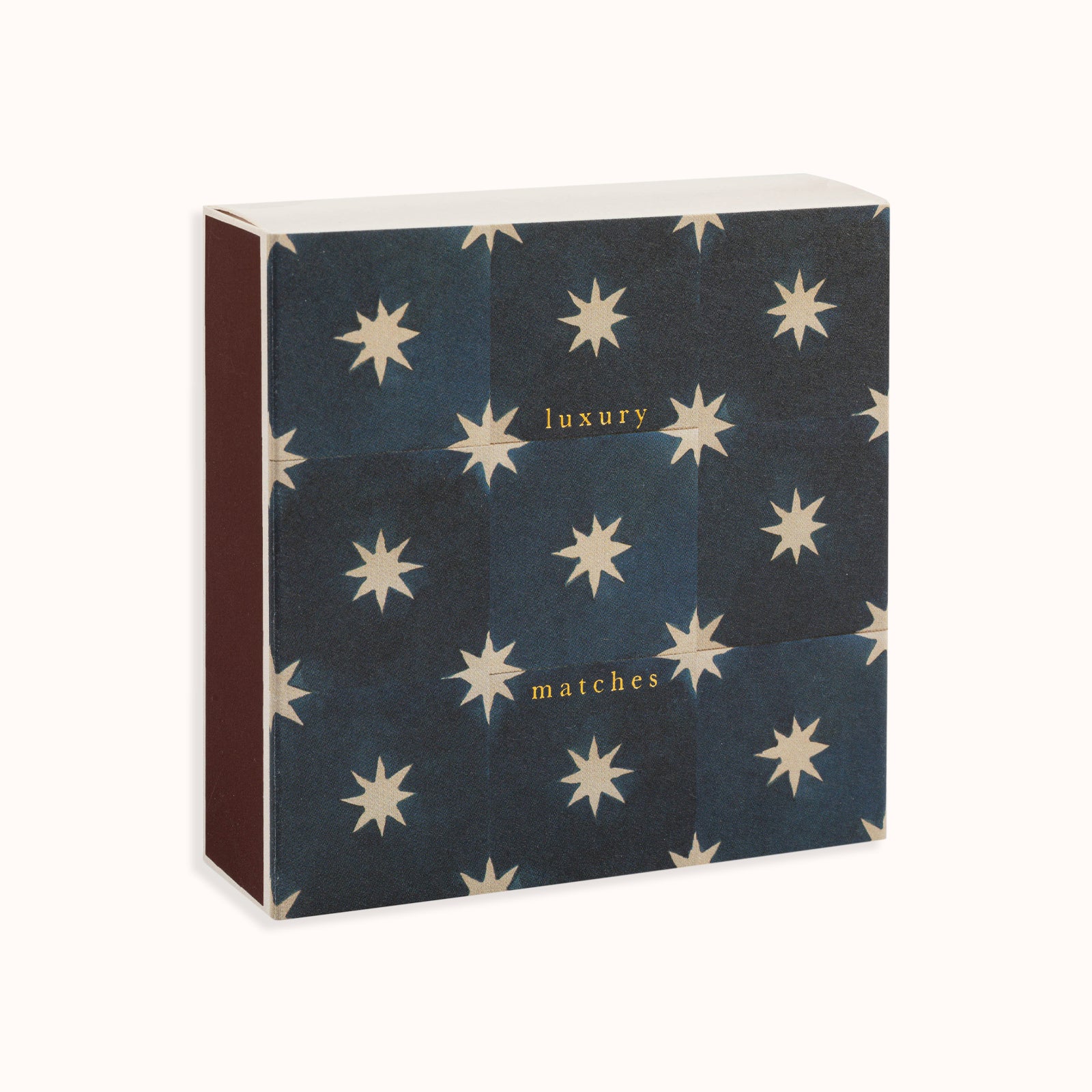 A navy blue matchbox with white star patterns and the text 'luxury matches' on the cover. Part of the Archivist Gallery Collection, available at Wildschut Antiques.