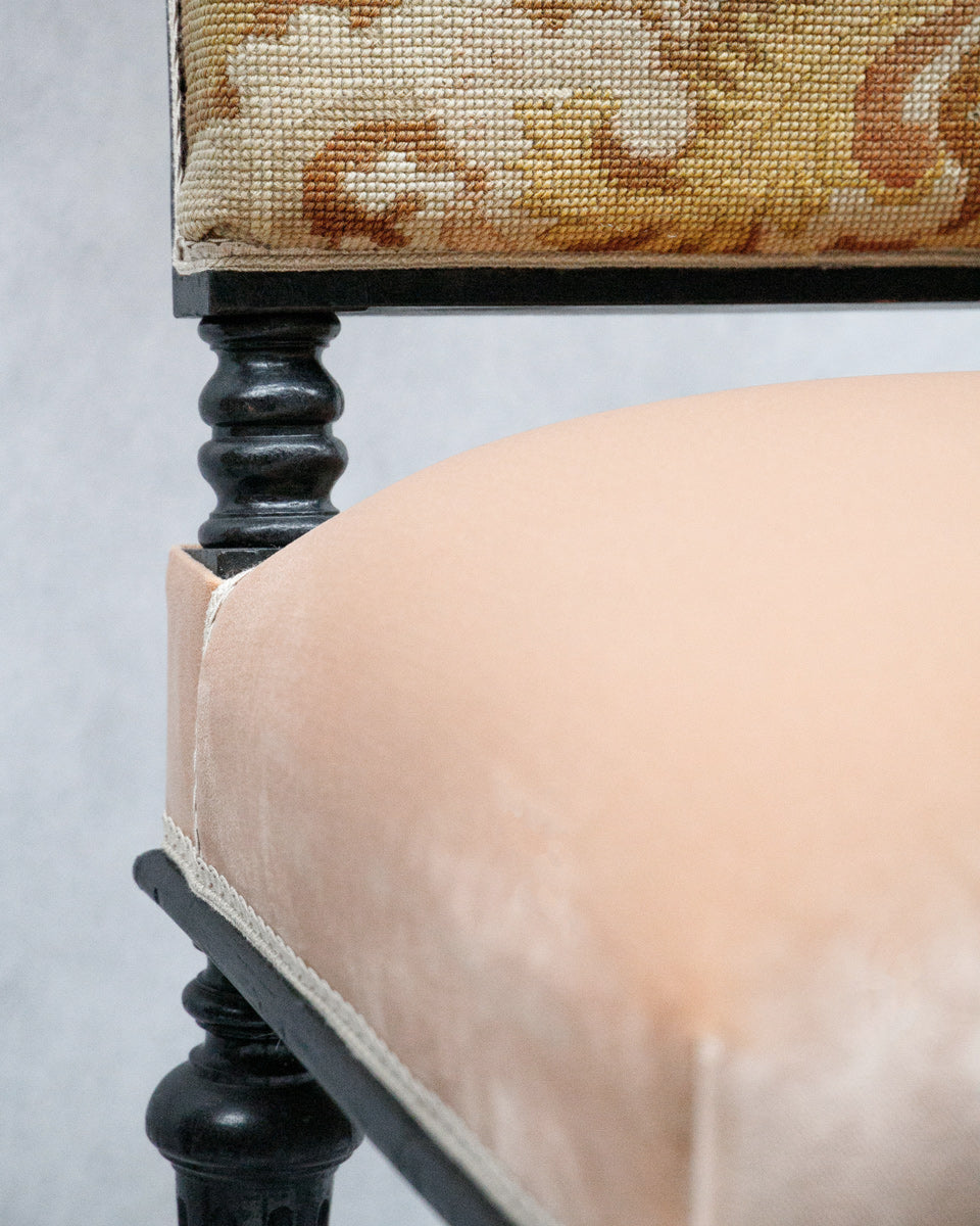 Close-up of a chair with decorative backrest and beige pink seating cushion