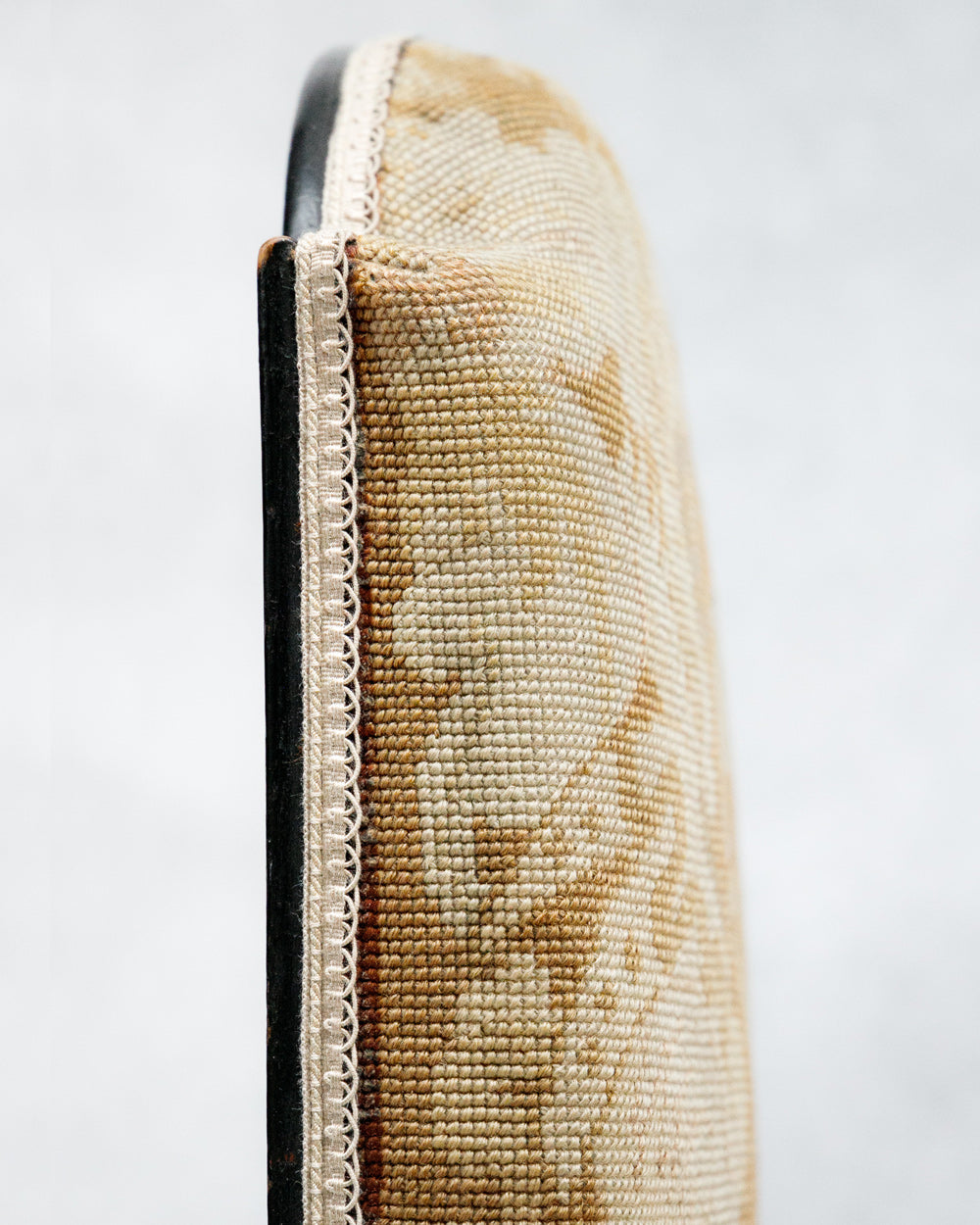 Close-up of a woven back of a chair with a textured surface on a white background
