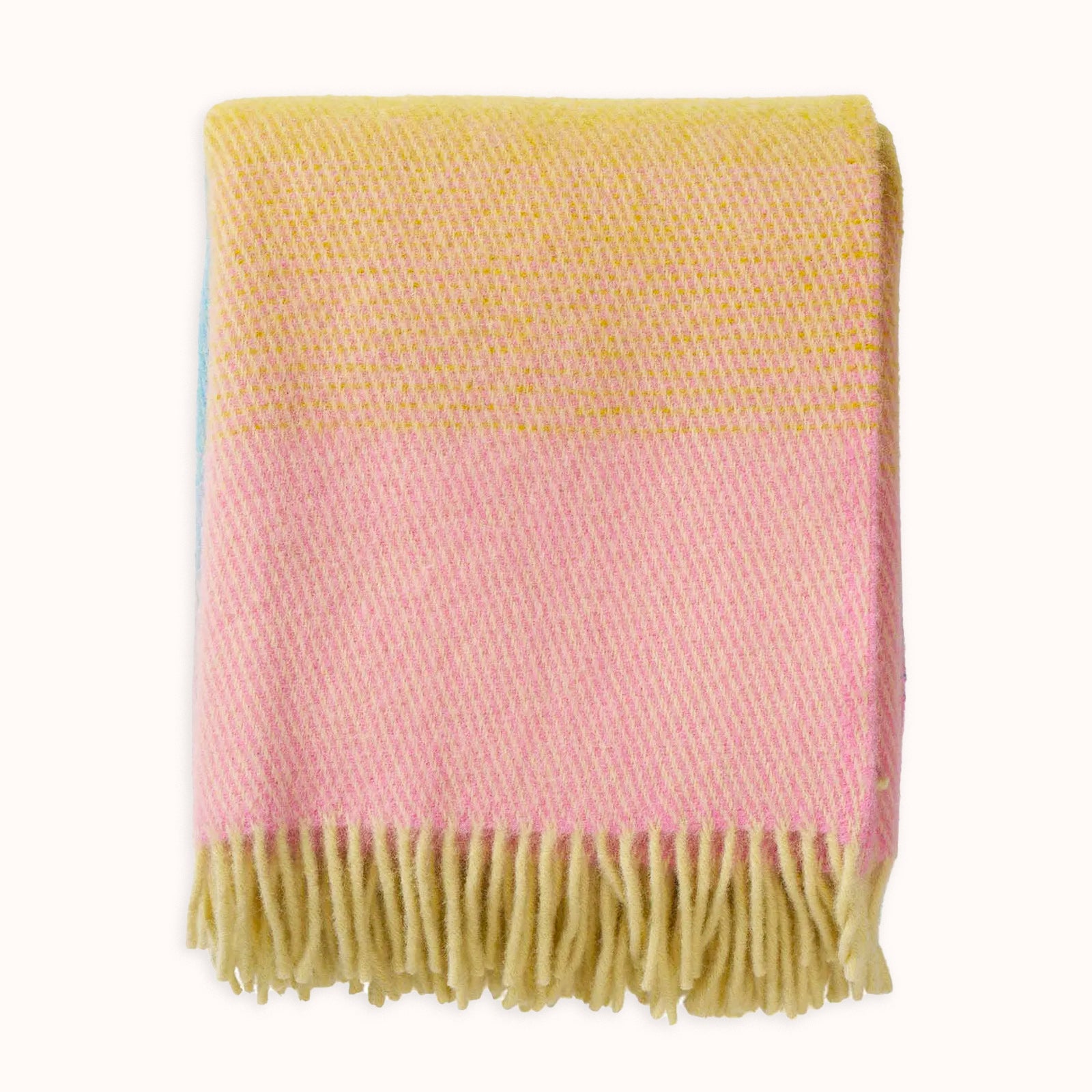 Gradient color wool blanket with yellow, pink, and blue stripes on a white background