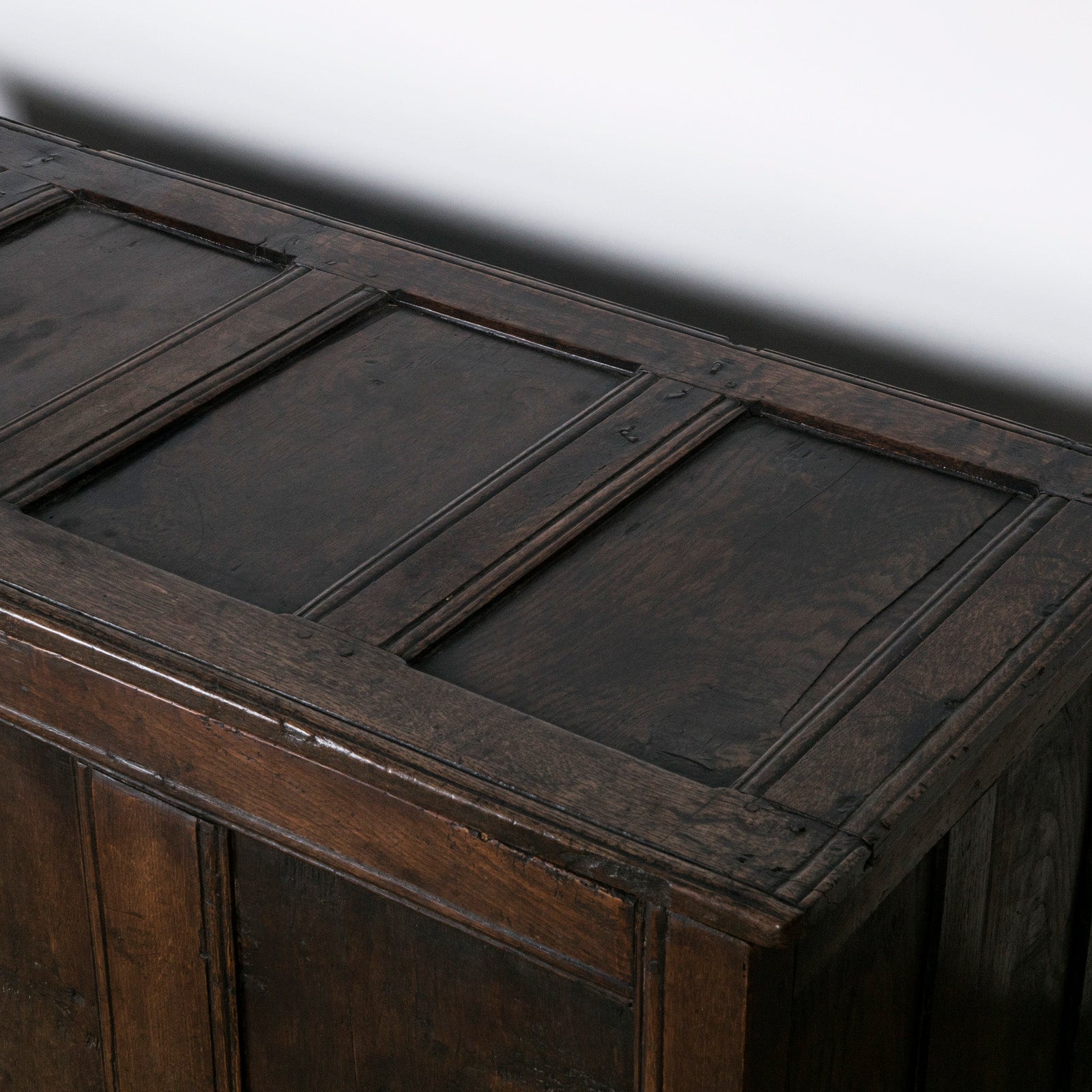 Top view of an antique early 18th-century solid oak chest or coffer, paneled and carved in warm brown tones. Available at Wildschut Antiques.
