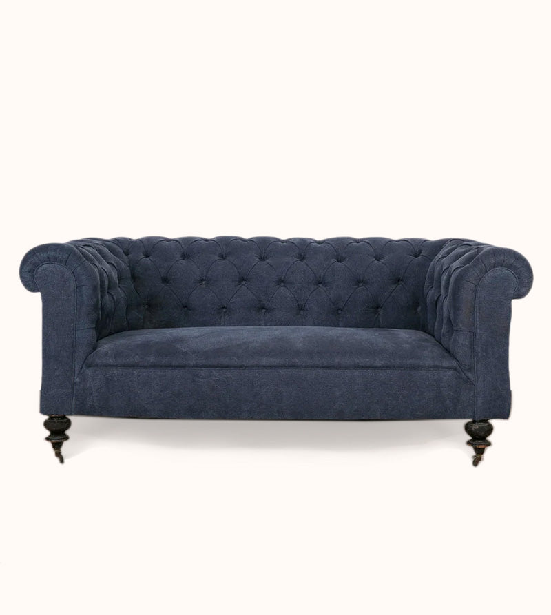 Elegantly tufted 19th-century French Napoleon III sofa upholstered in stonewashed blue linen, displayed against a clean background—available at Wildschut Antiques.