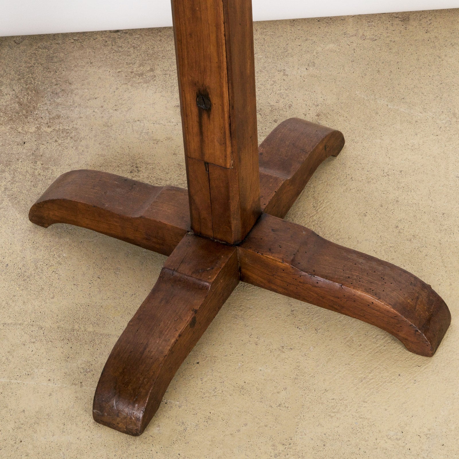 Close-up of the base of an antique wooden reading stand or book stand with an adjustable top and a rectangular base
