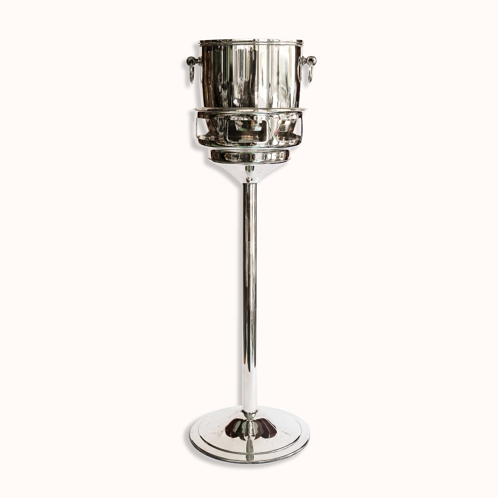 Vintage silver plated champagne bucket on a stand, with a sleek, cylindrical shape and a reflective surface, crafted by Christofle, available at Wildschut Antiques