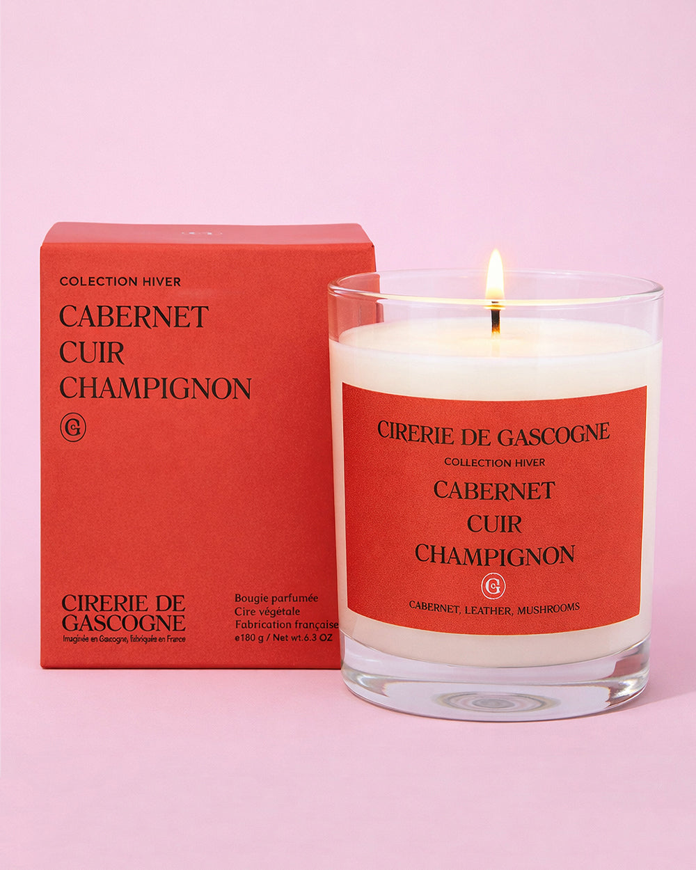 Cireré de Gascogne candle with red label and packaging on a pink background