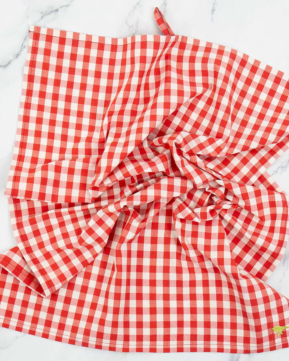 Red and white checkered tea towel on a white background