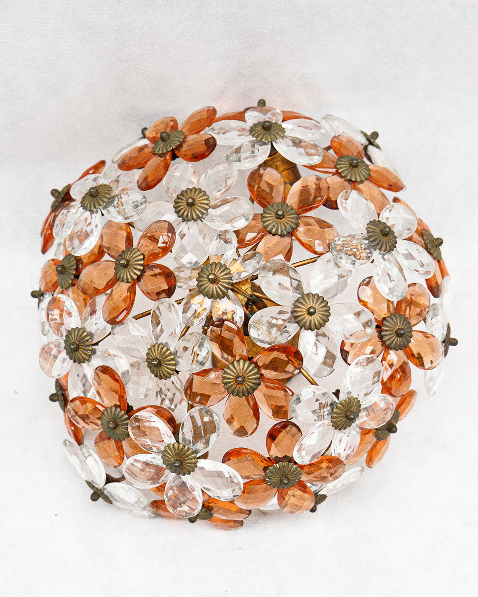 Decorative ceiling light fixture with orange and clear floral patterns on a white background