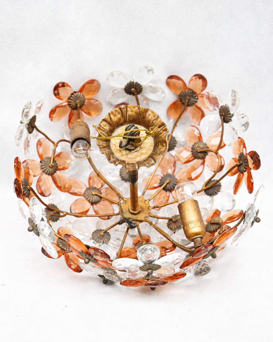 Decorative vintage ceiling light fixture with floral design on a white background