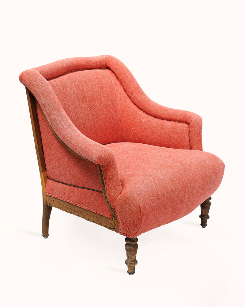 French antique Napoleon III-style armchair, upholstered in soft coral red fabric, set against a clean background - from Wildschut Antiques