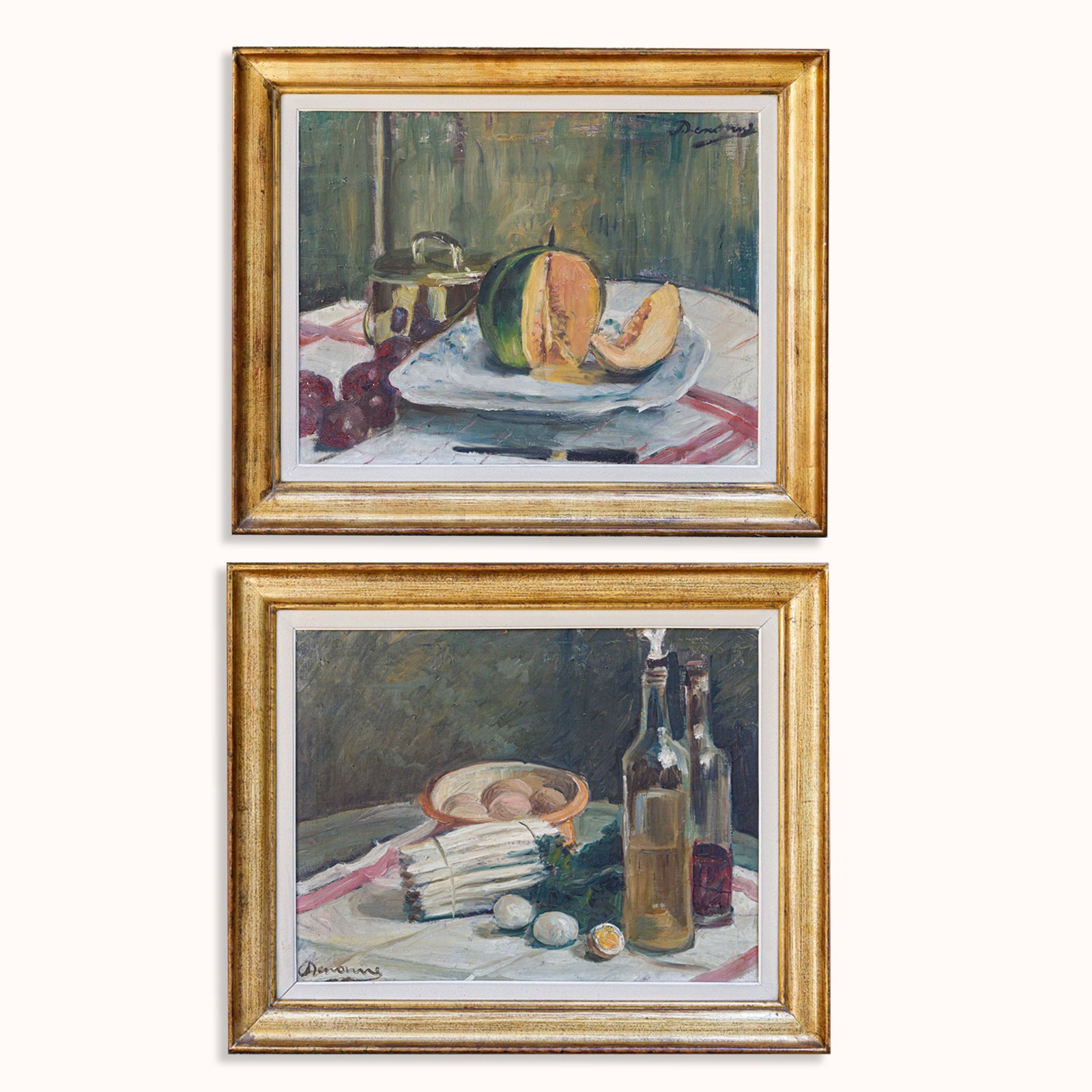 Gorgeous pair of early 20th-century still life paintings by Alexandre 'Alex' Denonne (Belgium, 1879–1953): one featuring asparagus and eggs with two bottles, the other depicting a sliced melon on a white plate. Displayed against a clean background. Available at Wildschut Antiques.
