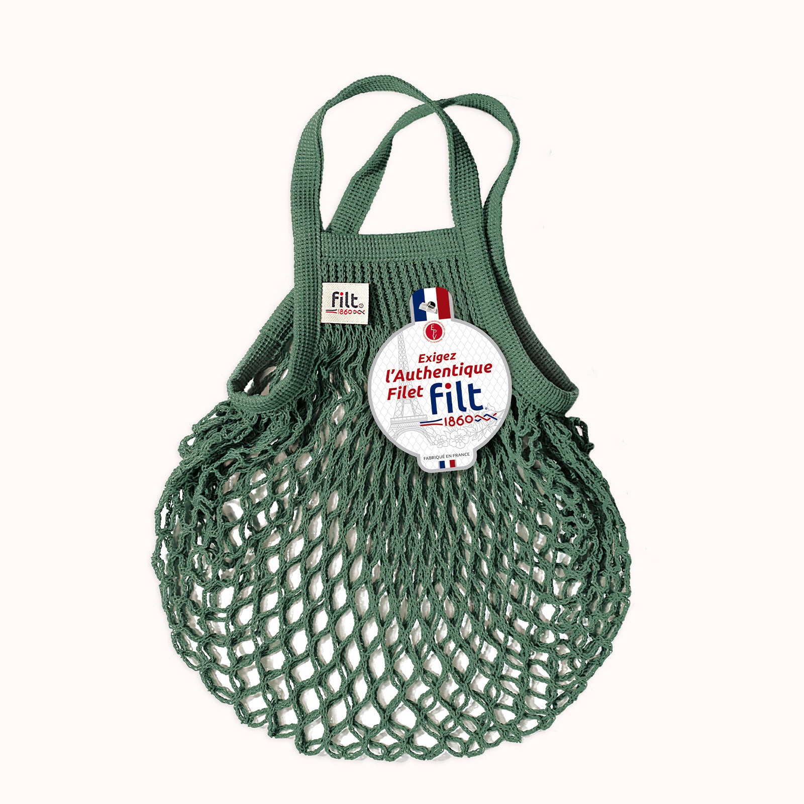Green mesh shopping bag with Filt 1860 logo on a white background, available at Wildschut Antiques