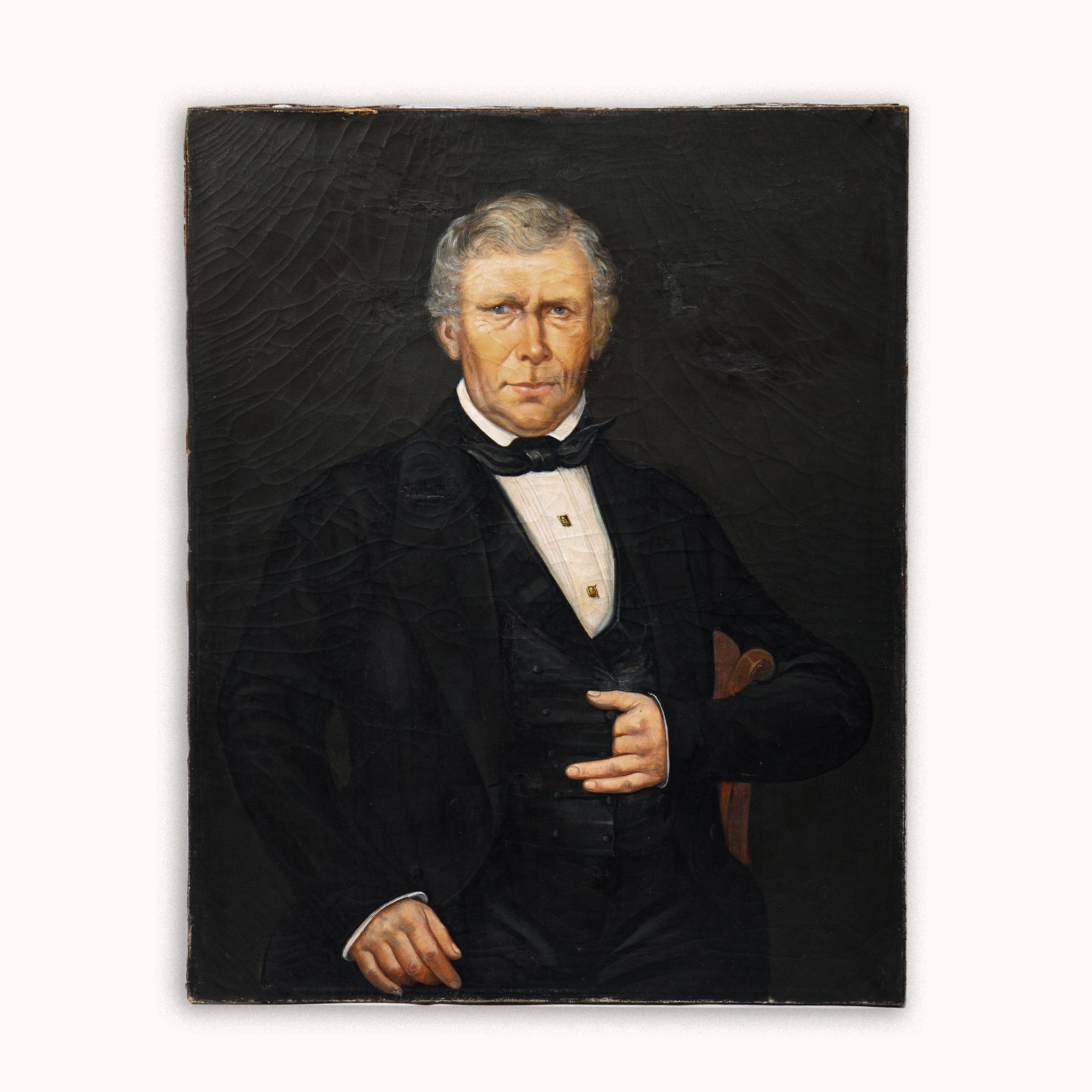 Antique 19th-century oil portrait of a man in formal attire set against a dark background - Wildschut Antiques Collection