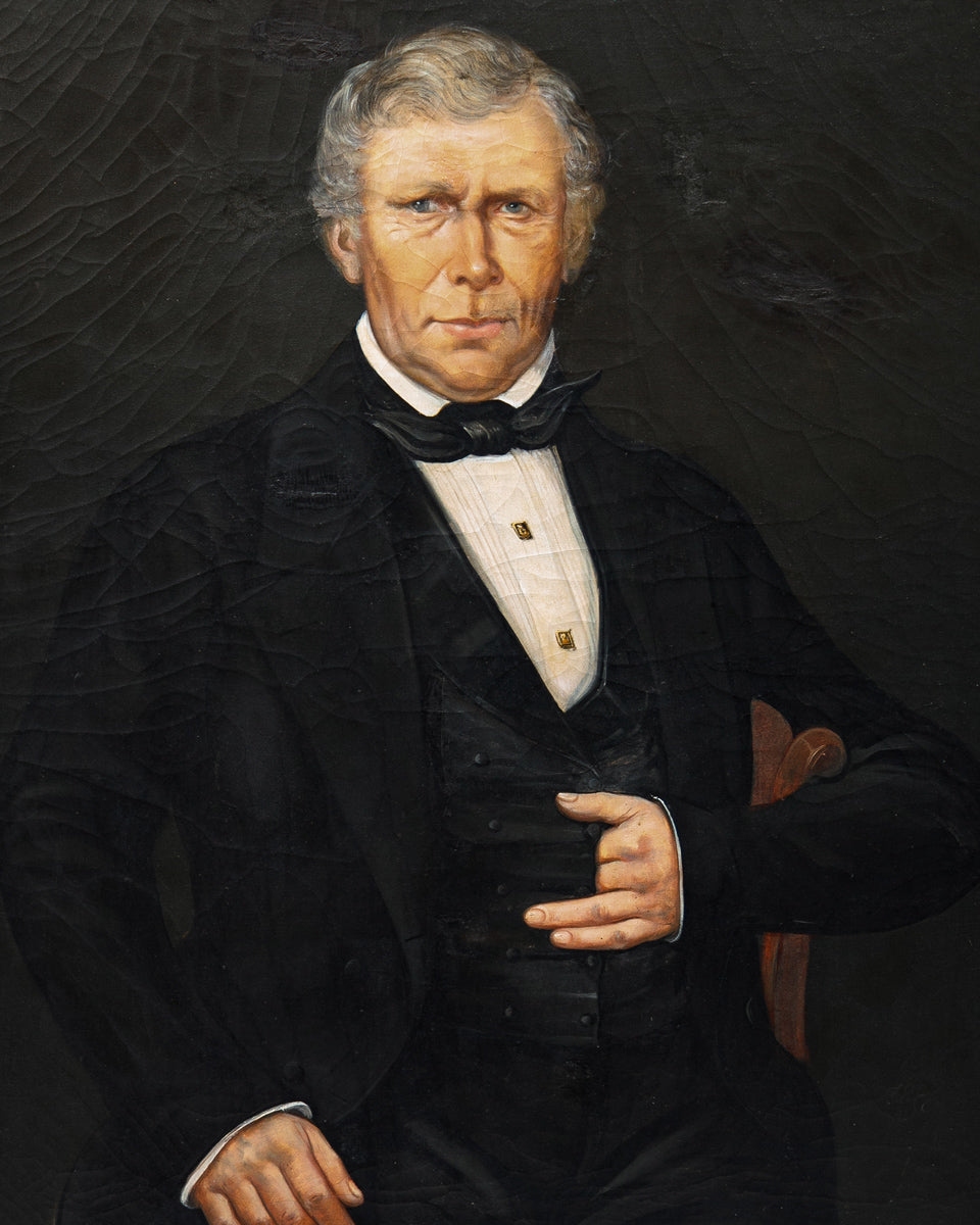 Close-up of an antique 19th-century oil portrait of a man in formal attire set against a dark background