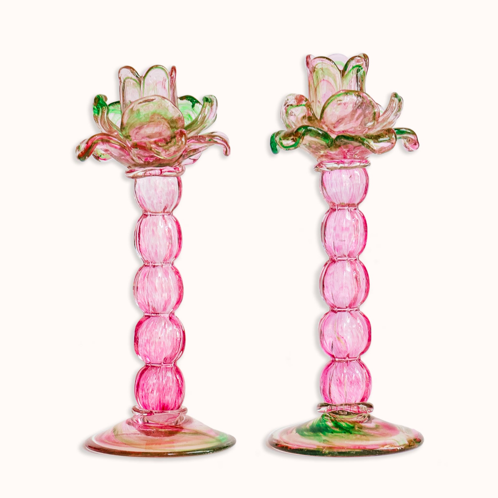 A pair of vintage Murano glass palm tree candle holders in green and pink colors, available at Wildschut Antiques