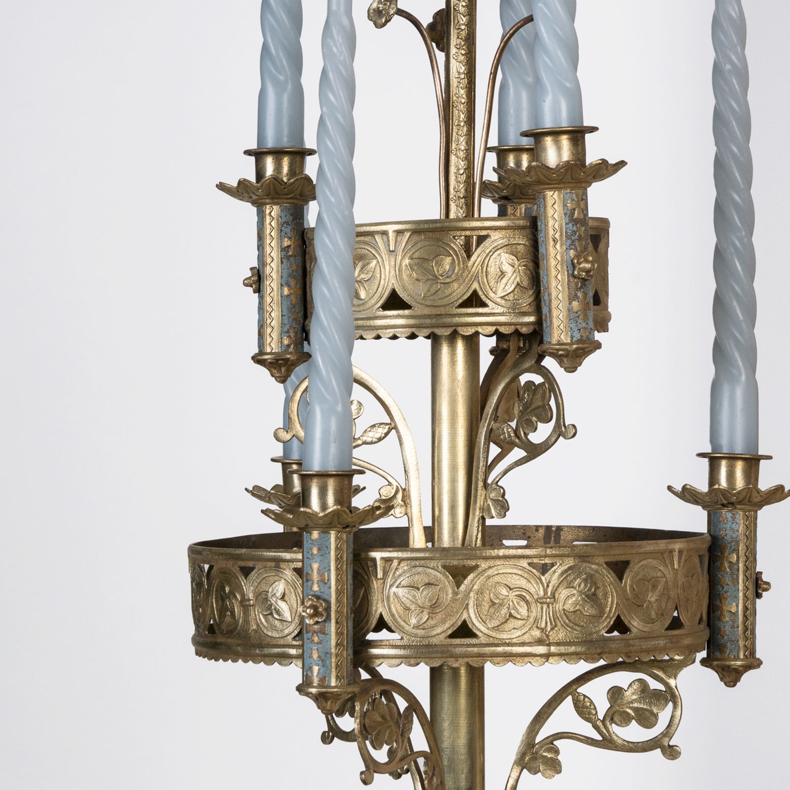 Close-up of a 19th century Gothic style candle sconce with gold-colored metal mountings and light blue swirl candles, designed for wall mounting, available at Wildschut Antiques