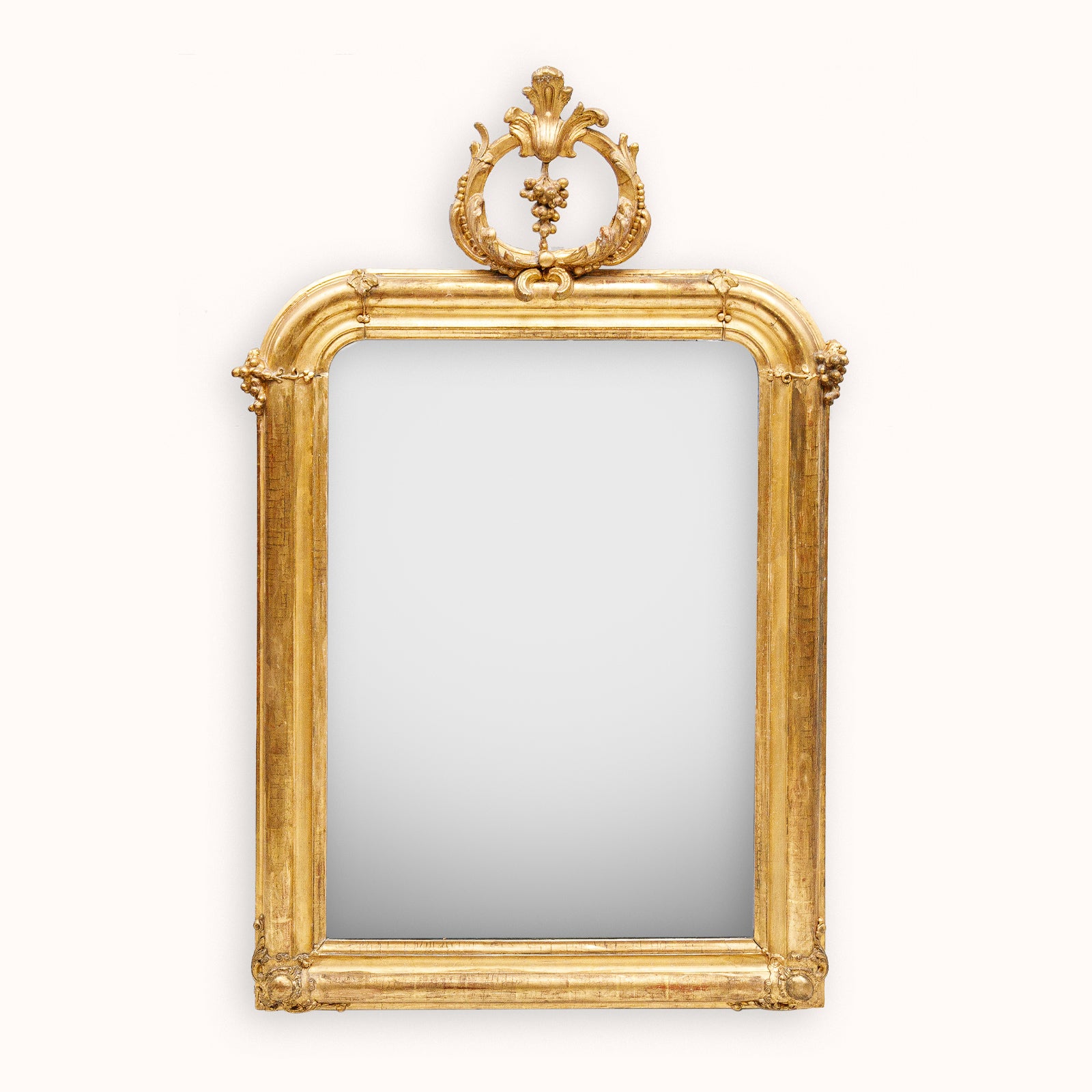 Decorative antique gold-framed mirror with an elaborate grapevine crest from Wildschut Antiques