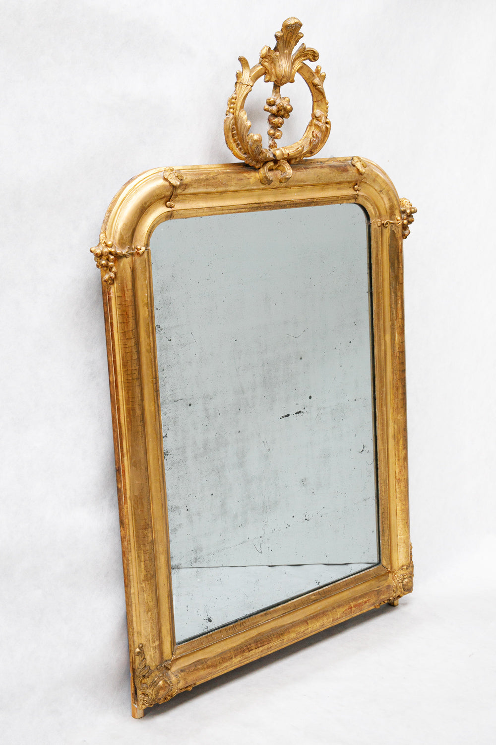 French antique gold-framed mirror with a decorative top in a grapevine and leaves shape from Wildschut Antiques
