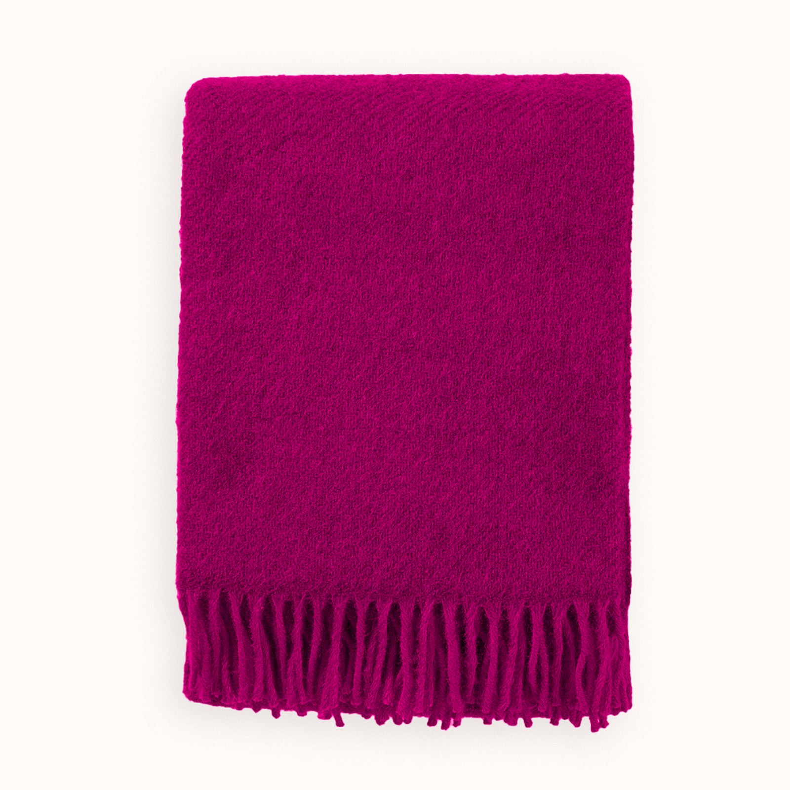 Cerise pink wool blanket throw with fringes on a white background