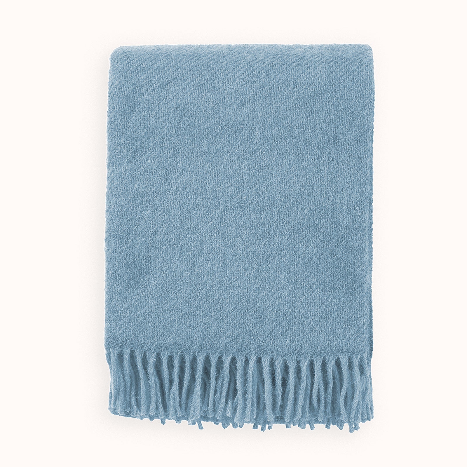 Blue wool throw blanket with fringes on a white background