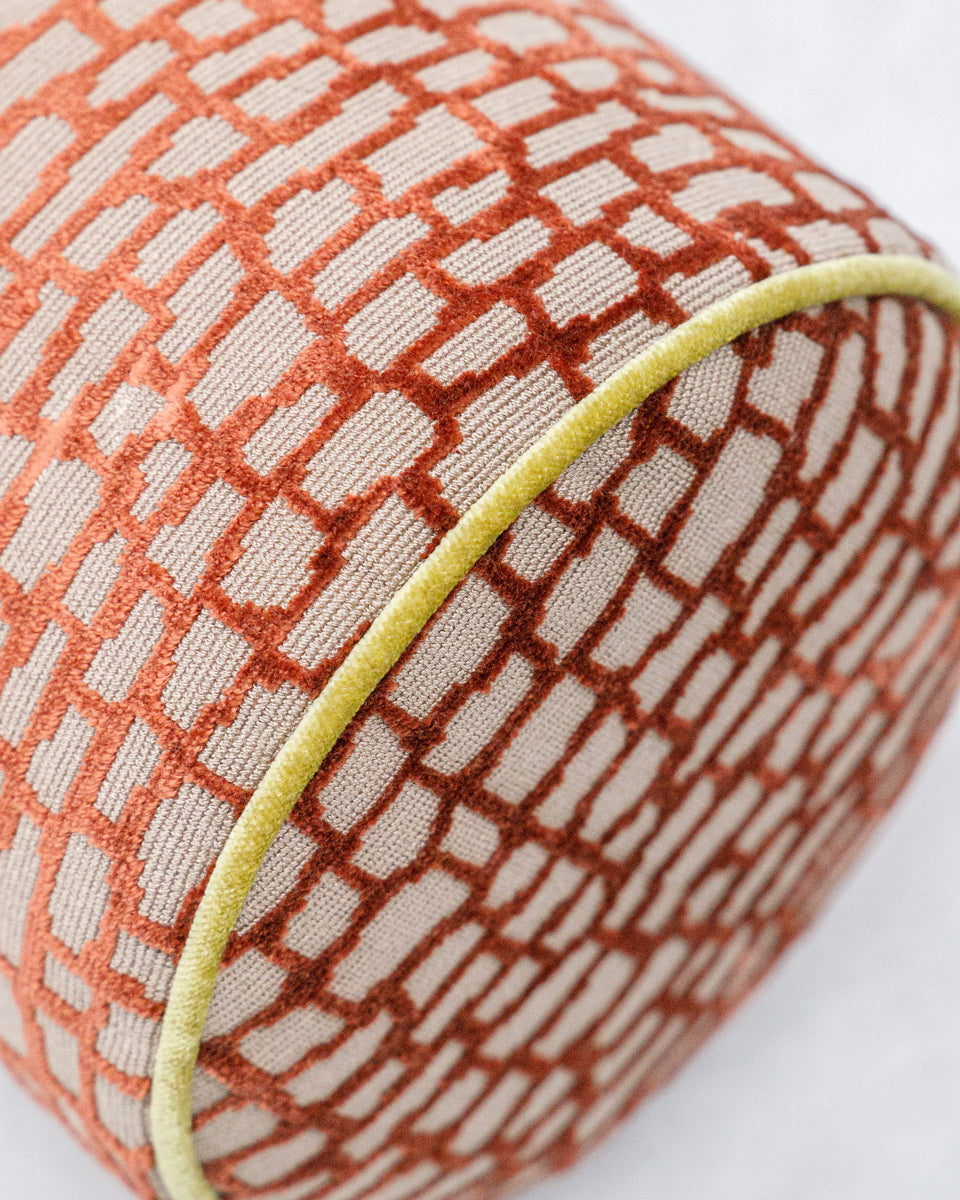 Textured fabric bolster pillow with geometric pattern on a white background