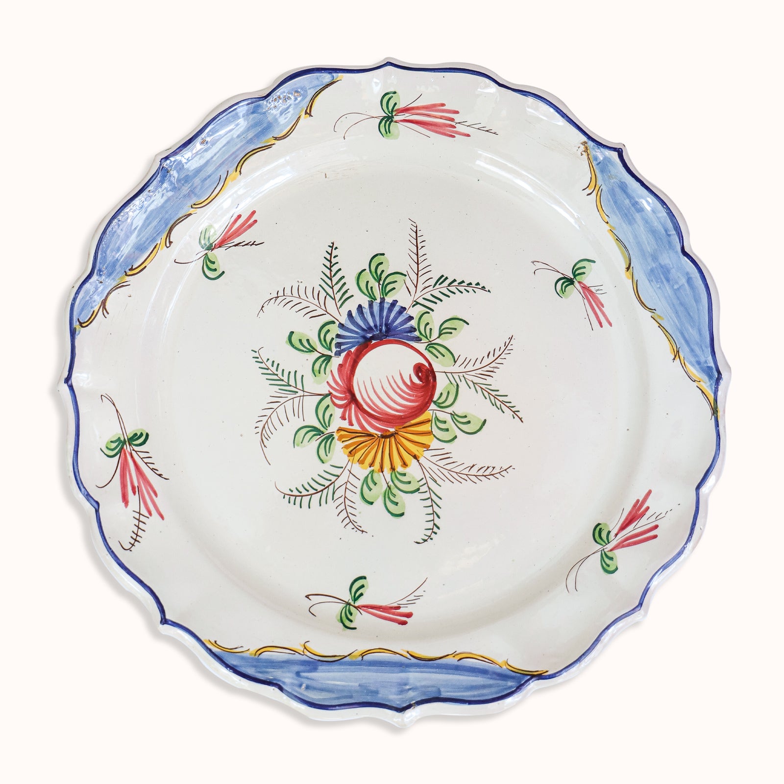 A large vintage hand-painted Italian ceramic plate with a floral design, predominantly white with blue and yellow accents along the rim, available at Wildschut Antiques