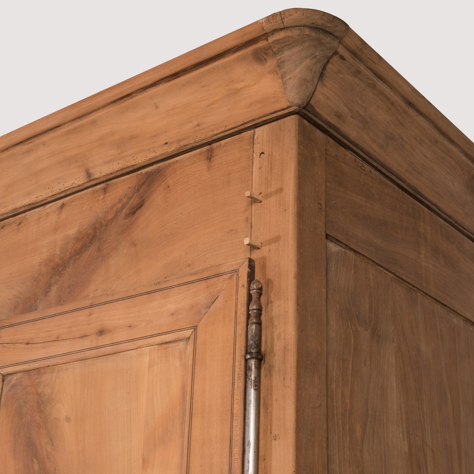 Close-up of an antique French Louis Philippe style armoire made from hand-sanded cherry wood