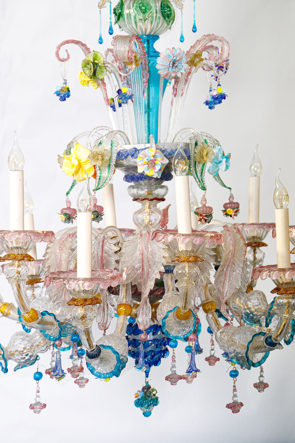 Details of a colorful large vintage Venetian Murano Glass chandelier with intricate flower designs on a white background, available via Wildschut Antiques