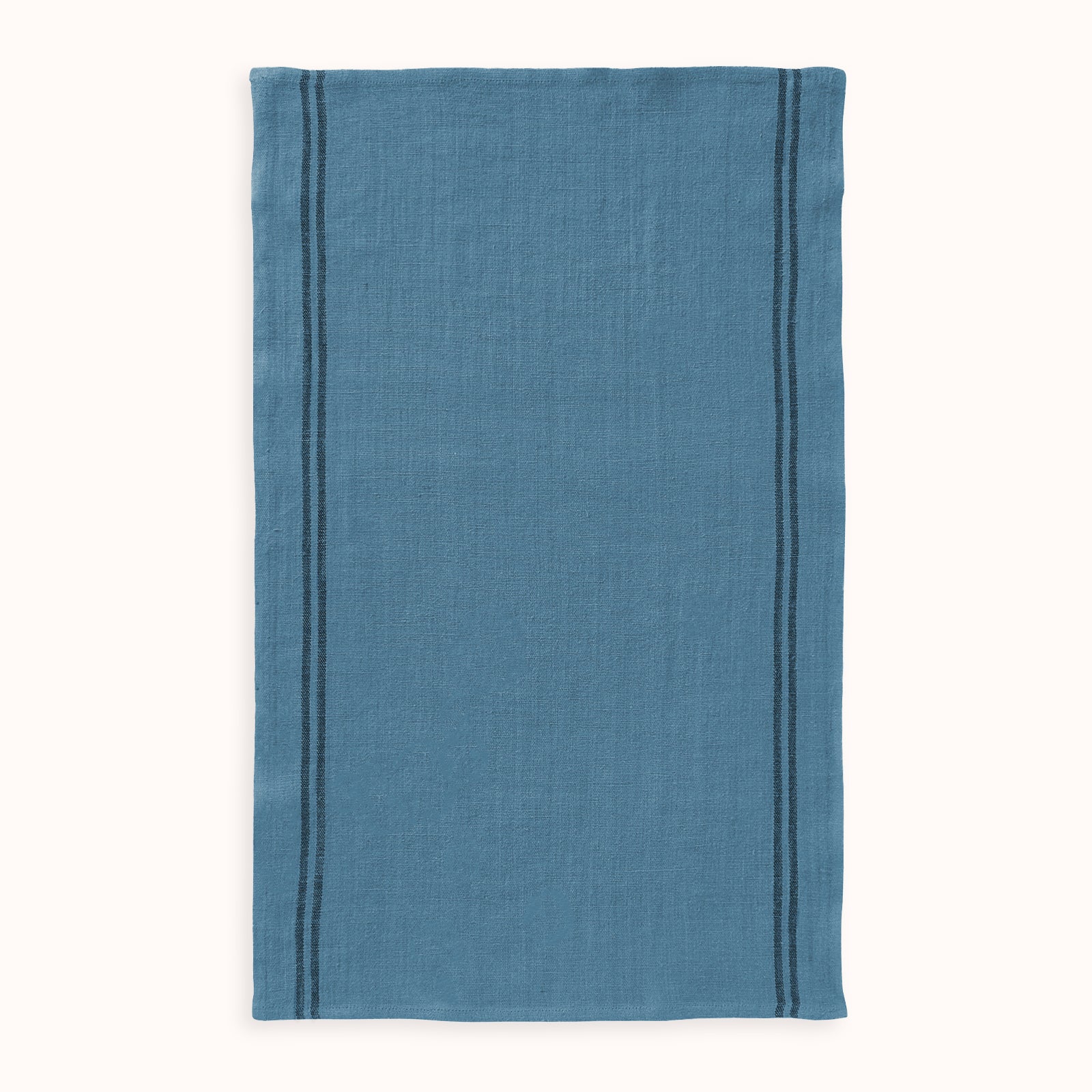 A blue linen dish towel with a textured weave and dark stripes by Charvet Editions available at Wildschut Antiques