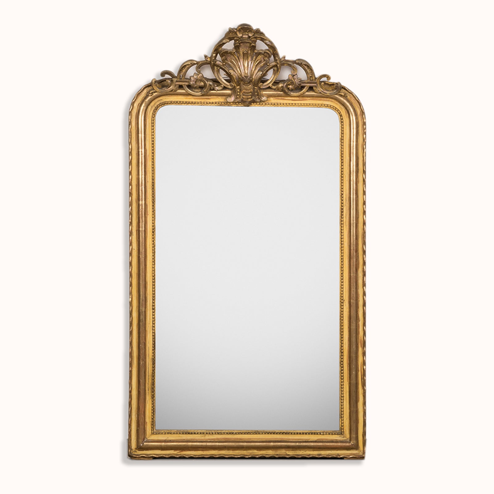 Antique 19th-century French Louis Philippe-style gilt mirror featuring a decorative crest and pearl beading along the inner perimeter. Displayed against a clean background. Available at Wildschut Antiques.