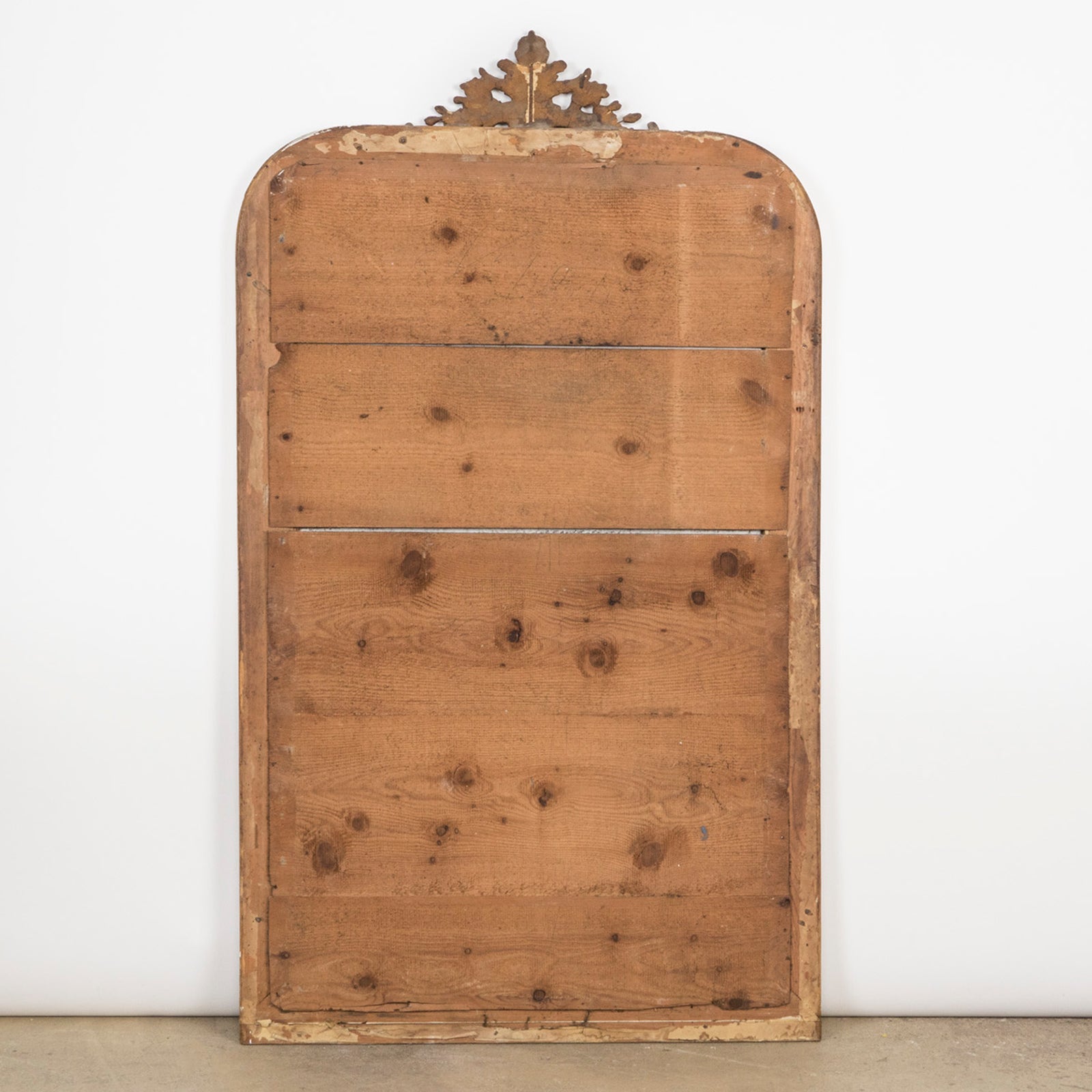 Wooden backside of an antique French 19th Century Louis Philippe style gold gilt mirror with a small crest